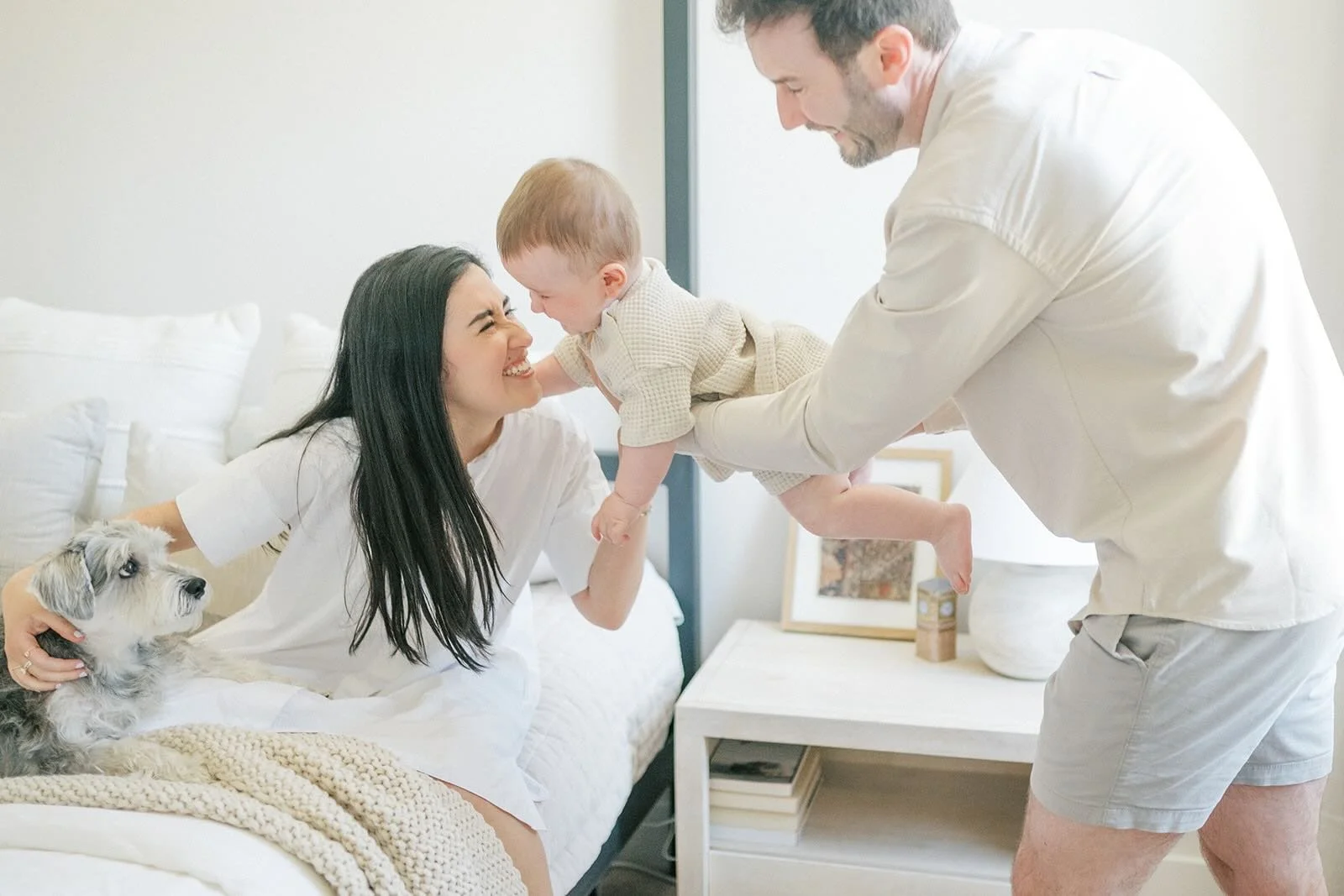 Dad holding son to give Mom kisses - Raleigh Newborn Photographer