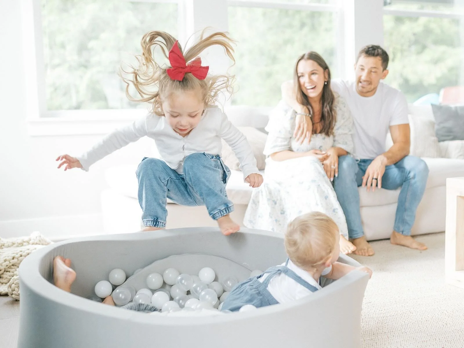 Mom and Dad watching children play in the ball pit - Raleigh Newborn Photographer