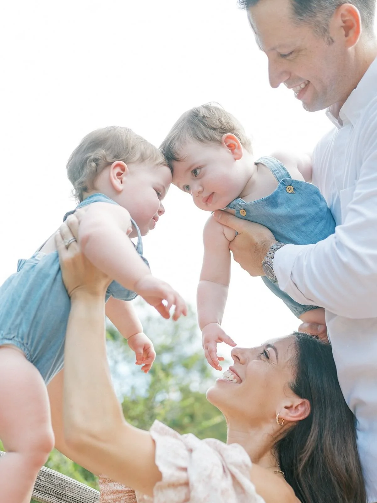 Mom and Dad holding twin boys - Raleigh Newborn Photographer