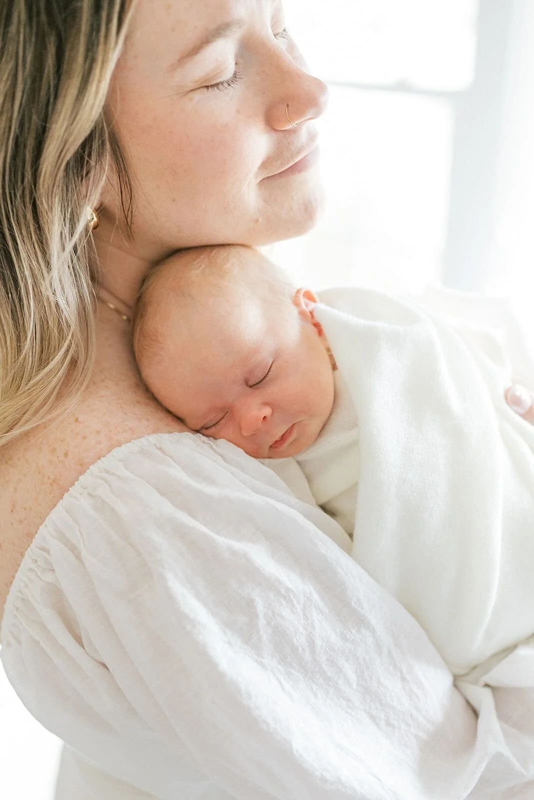 Mother snuggling baby - Raleigh Newborn Photographer