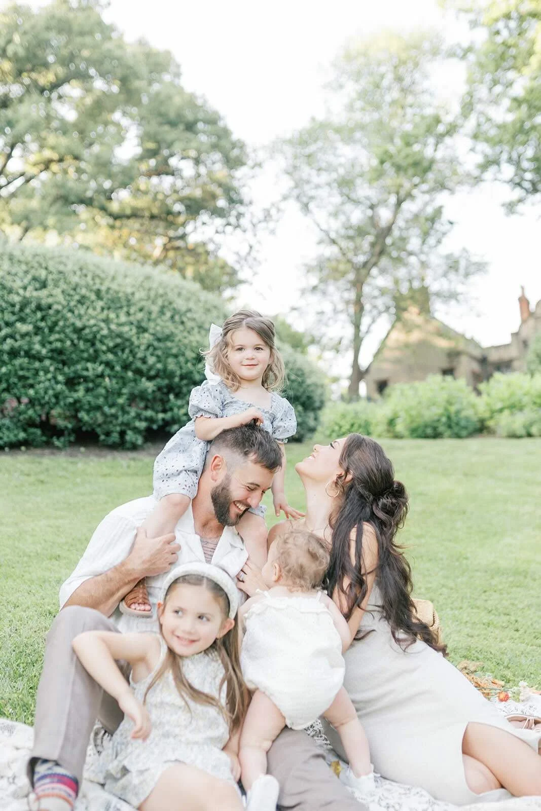 Family sitting on a blanket outside - Raleigh Newborn Photographer