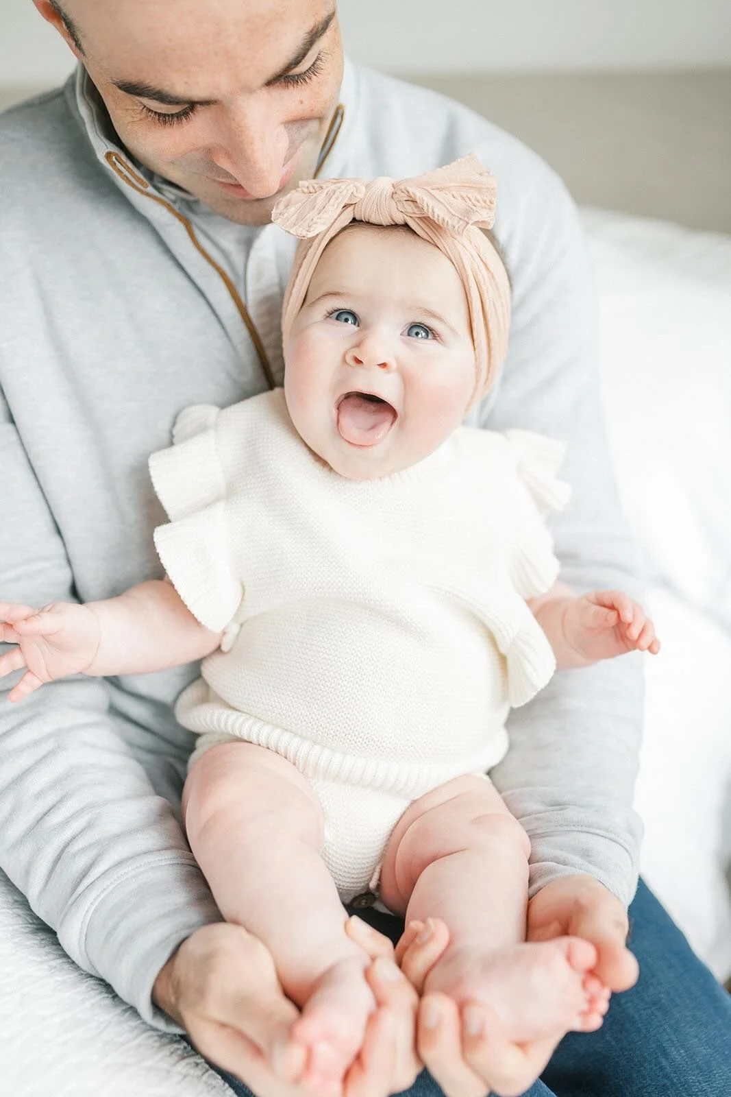 Big smiles while being held by Dad - Raleigh Newborn Photographer