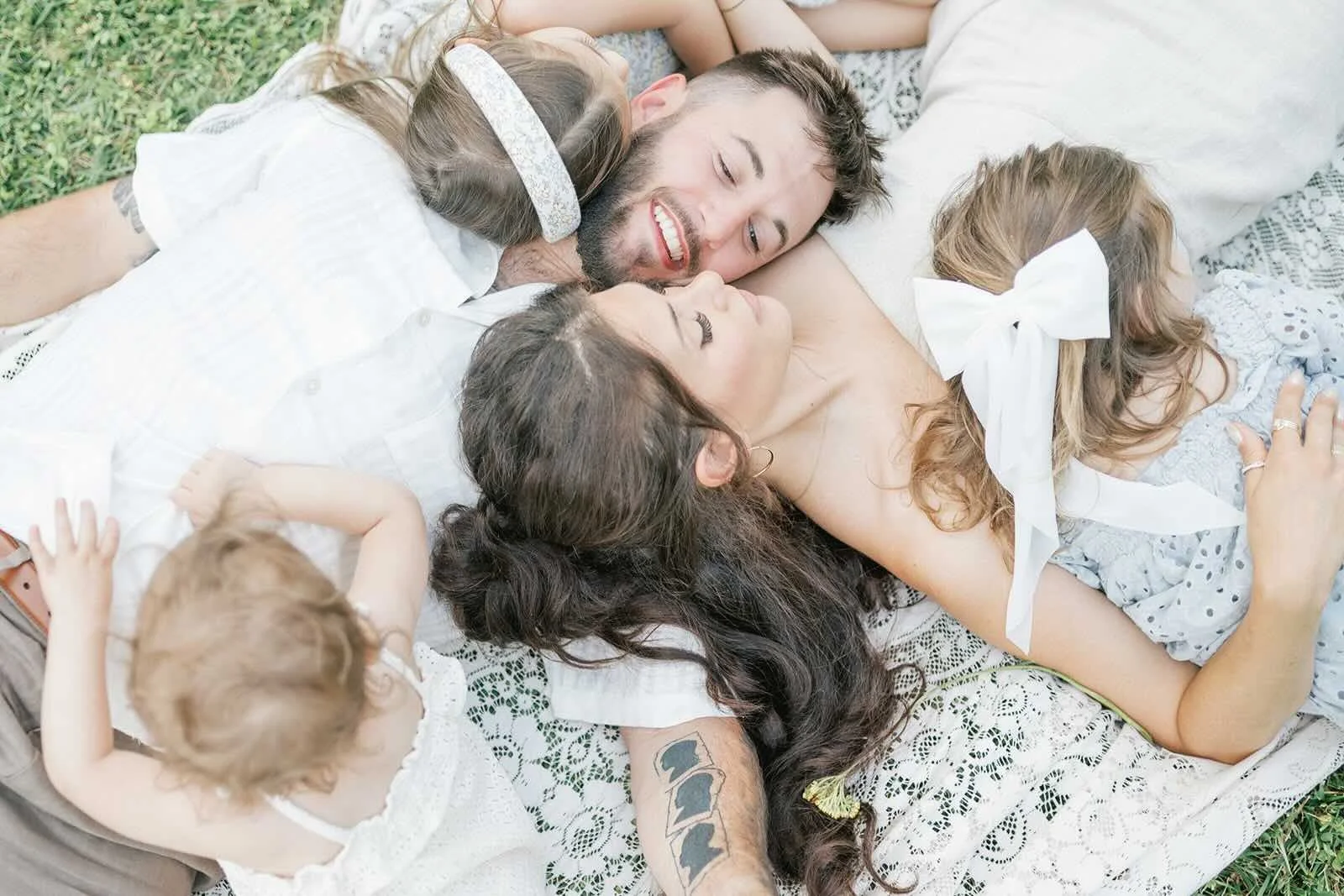 Family hugs laying outside - Raleigh Newborn Photographer