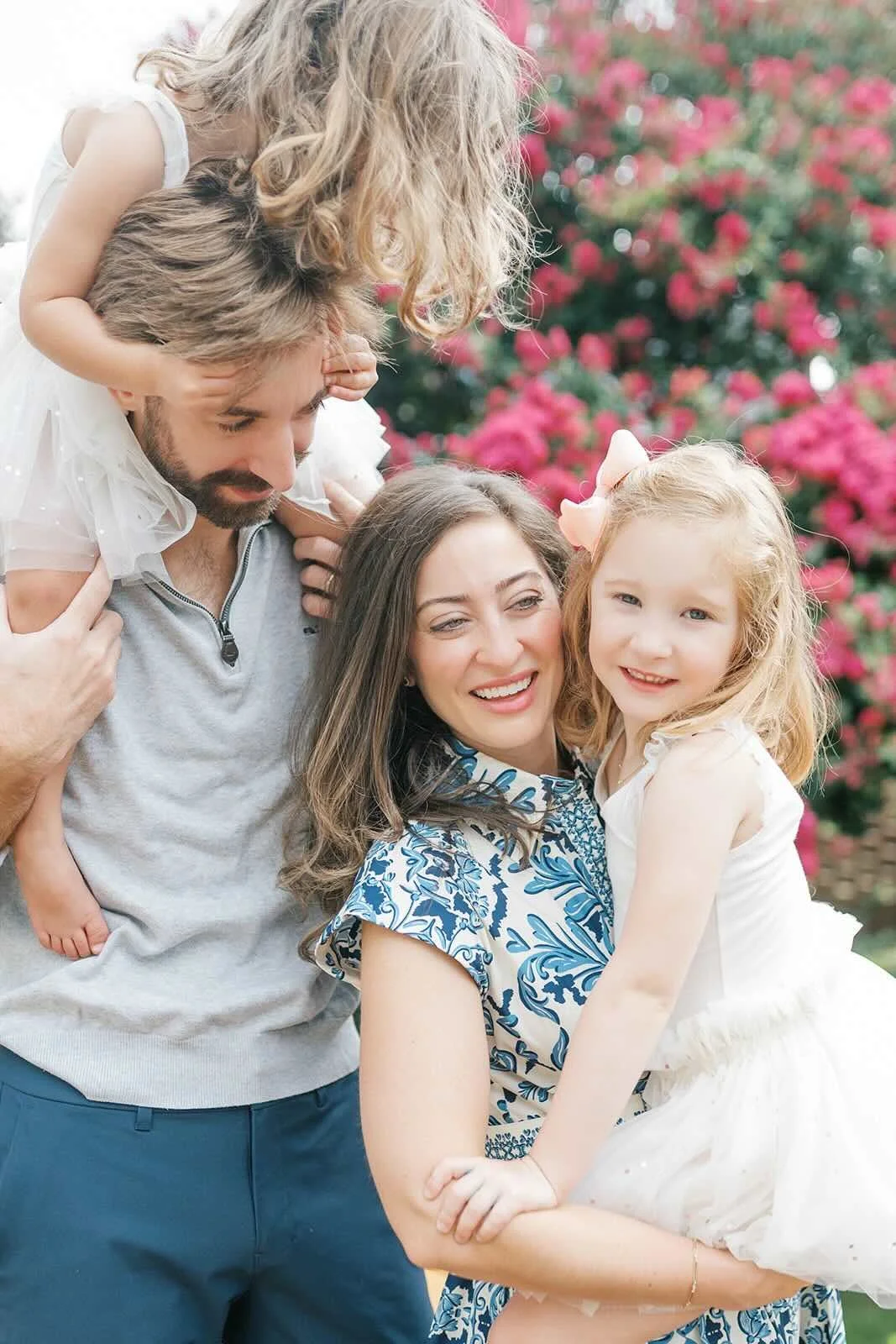 Mom and Dad holding their daughters - Raleigh Newborn Photographer