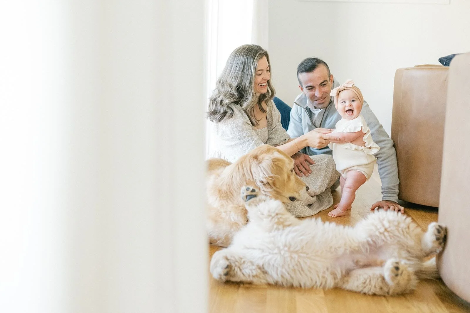 Mom and Dad holding daughter with their dogs - Raleigh Newborn Photographer