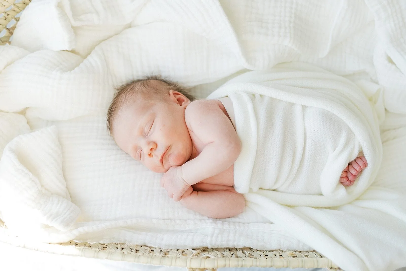 Swaddles baby in the natural light - Raleigh Newborn Photographer