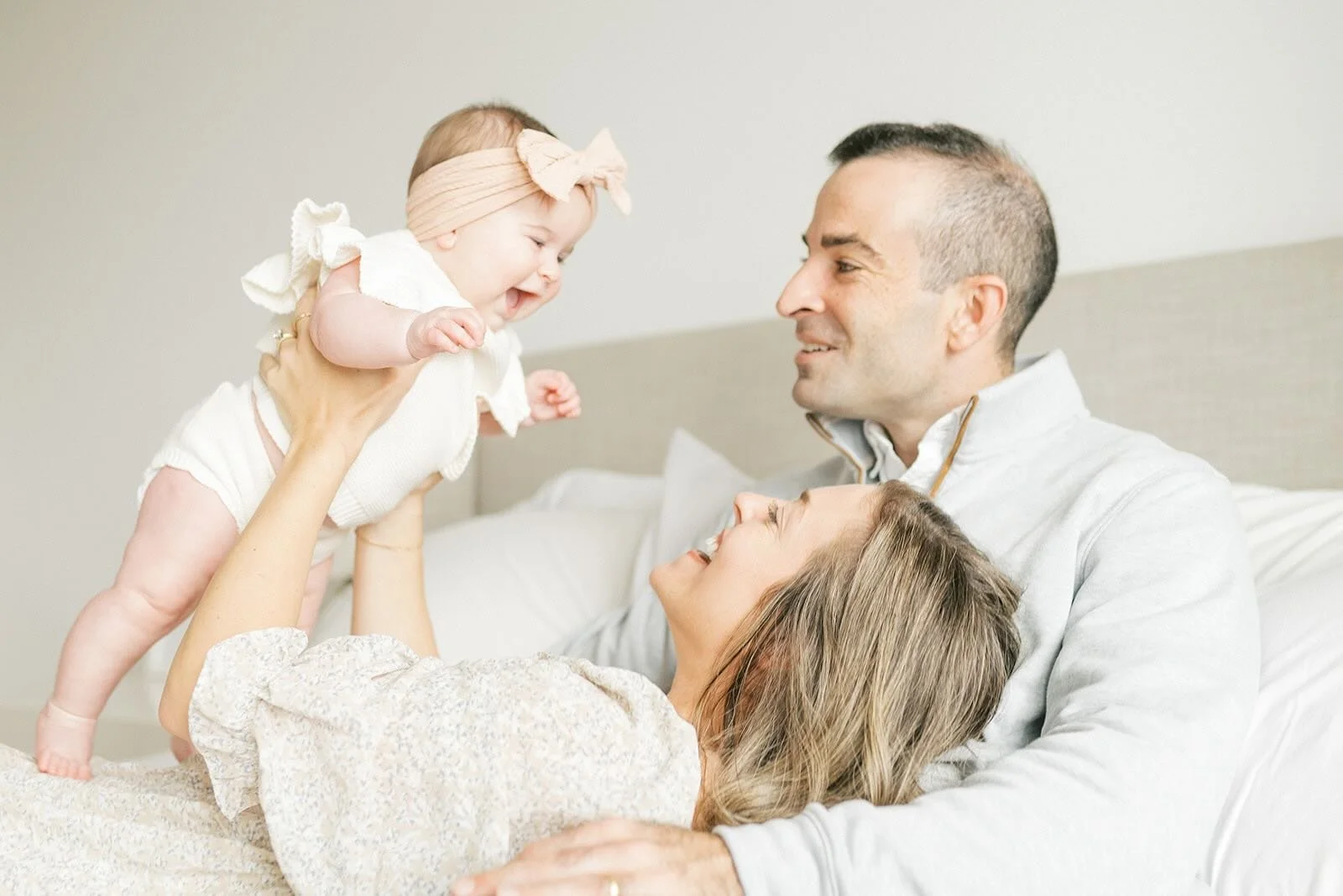 Mom and Dad smiling at daughter - Raleigh Newborn Photographer