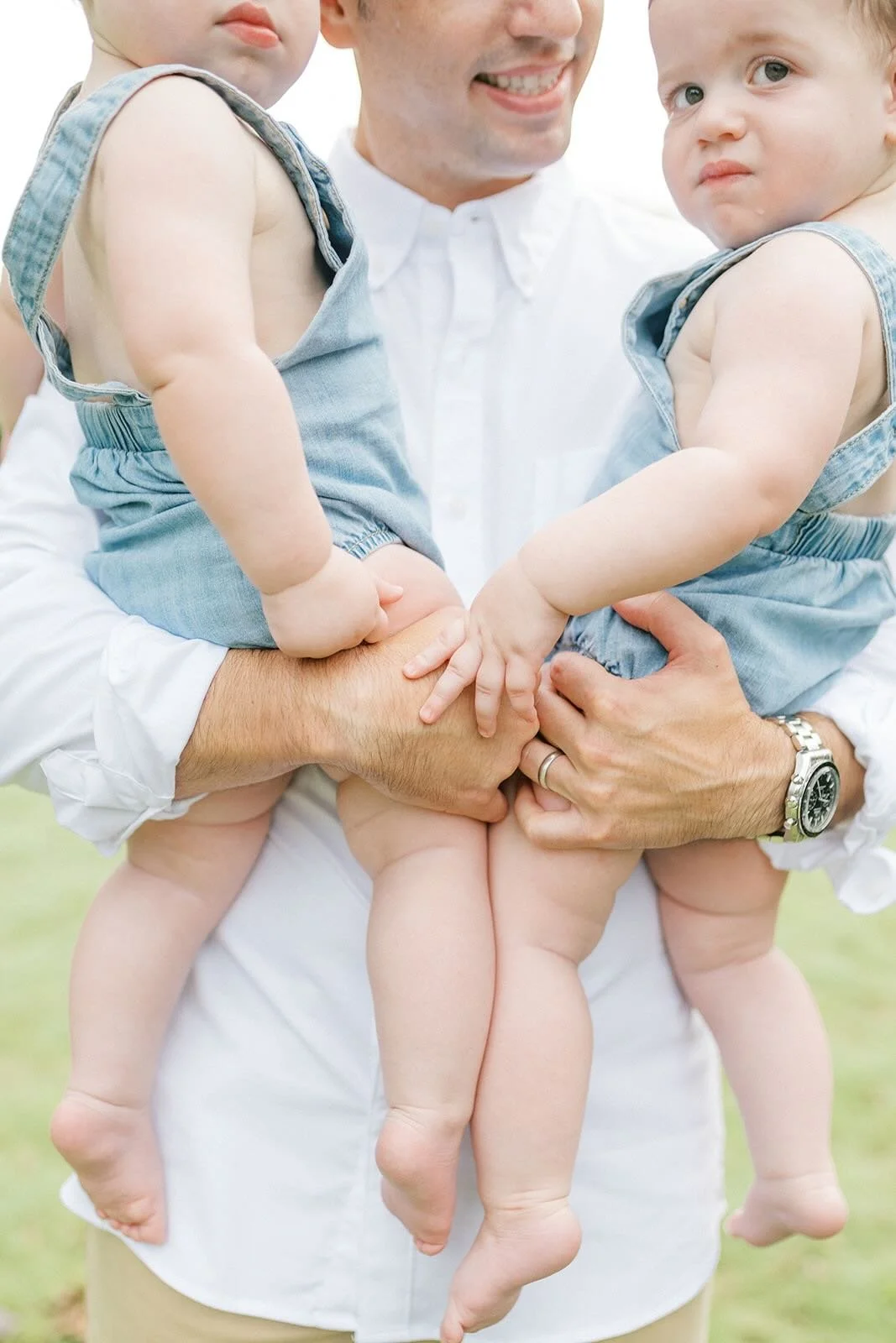 Dad holding his twin boys outside - Raleigh Newborn Photographer