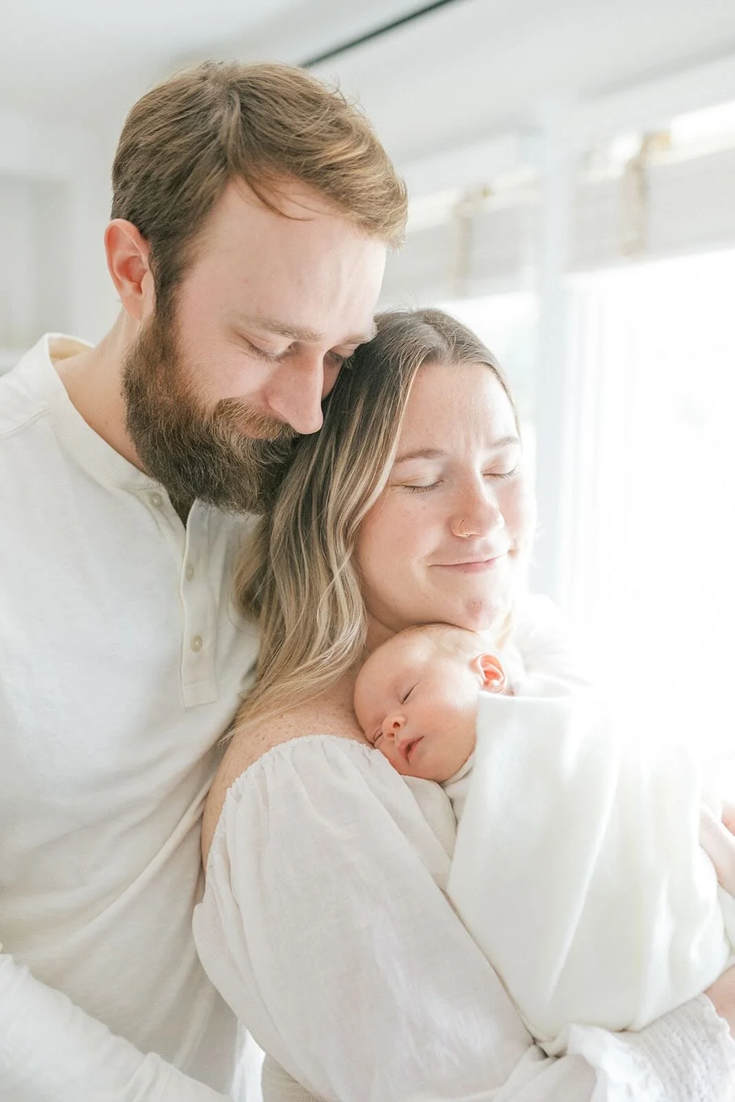 New family of three holding each other close - Raleigh Newborn Photographer