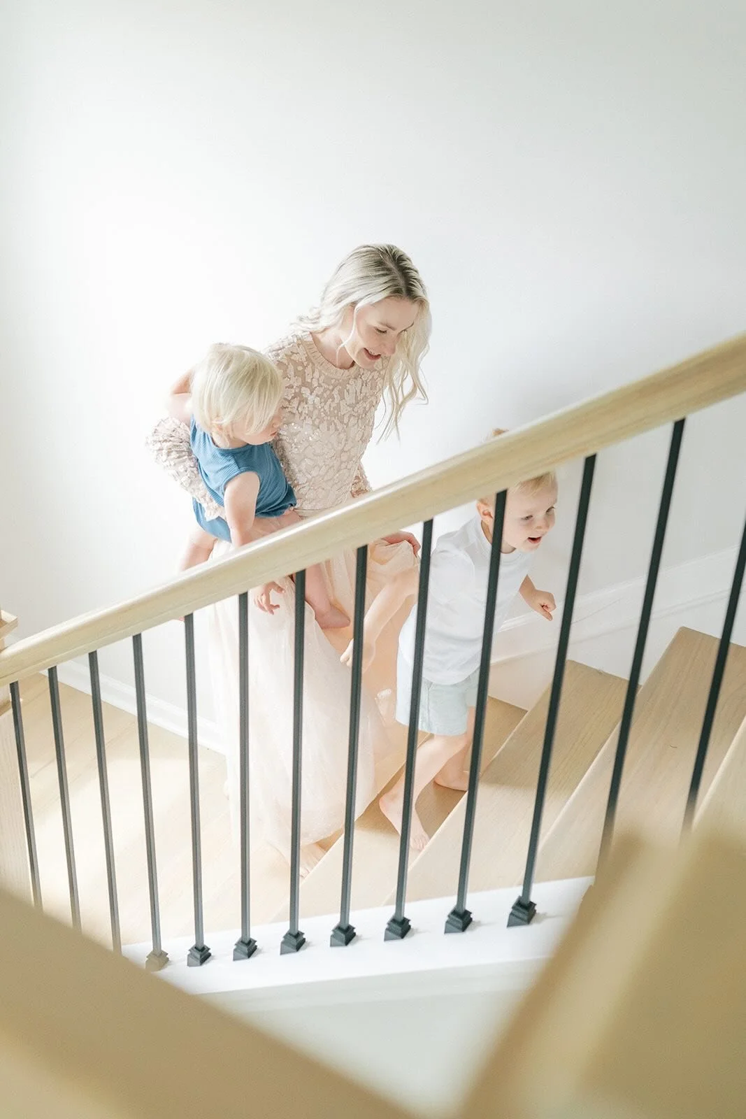 Mother walking up the stairs with her children - Raleigh Newborn Photographer