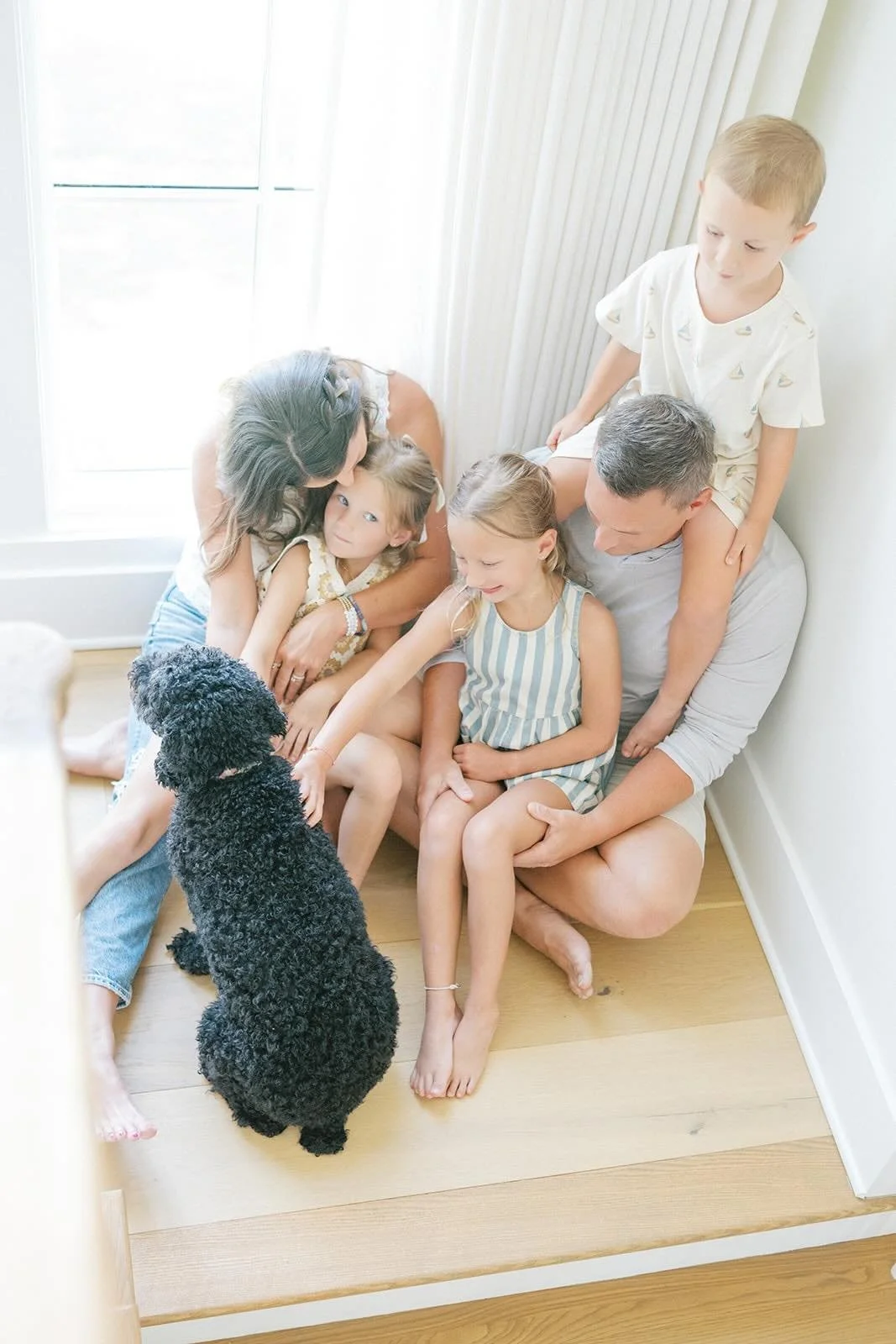 Family cuddles on the landing step - Raleigh Newborn Photographer