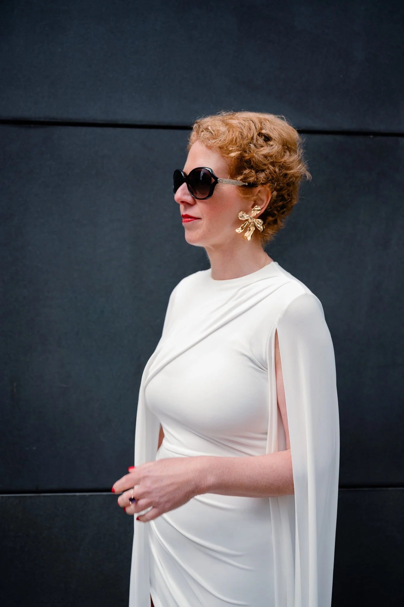 Founder in a white caped dress with sunglasses, brand photography by Tanja Pleis