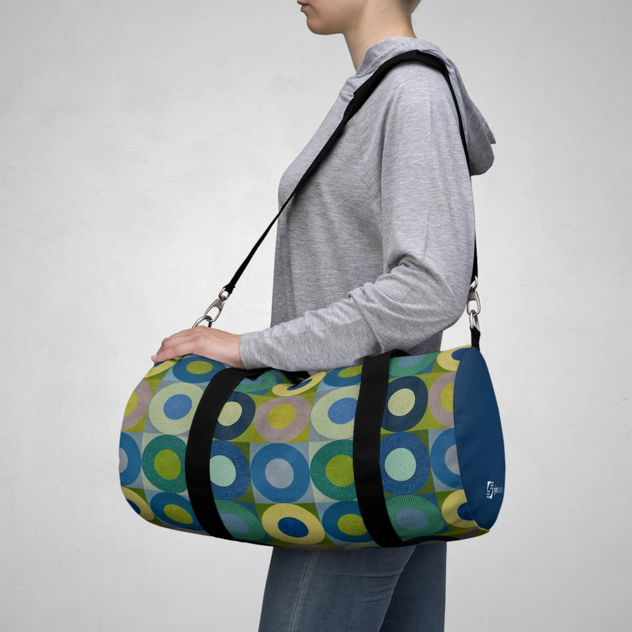Geometric art duffel bag featuring a colorful abstract design adapted from an original encaustic painting by Ross Ozer of rjostudio.