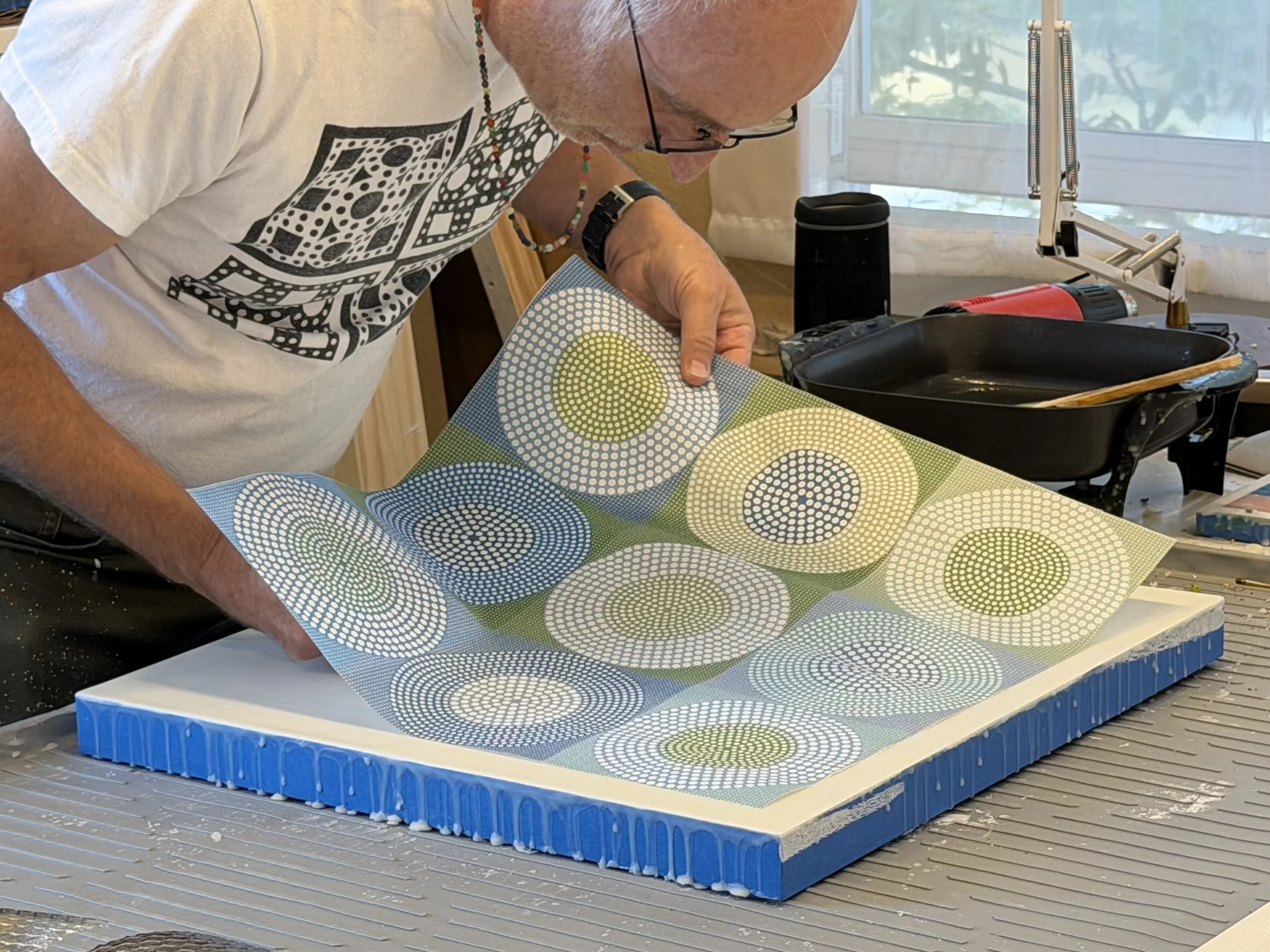 Artist Ross Ozer working in his Provincetown studio, creating geometric encaustic paintings using wax, pigment, and hand-applied marks.