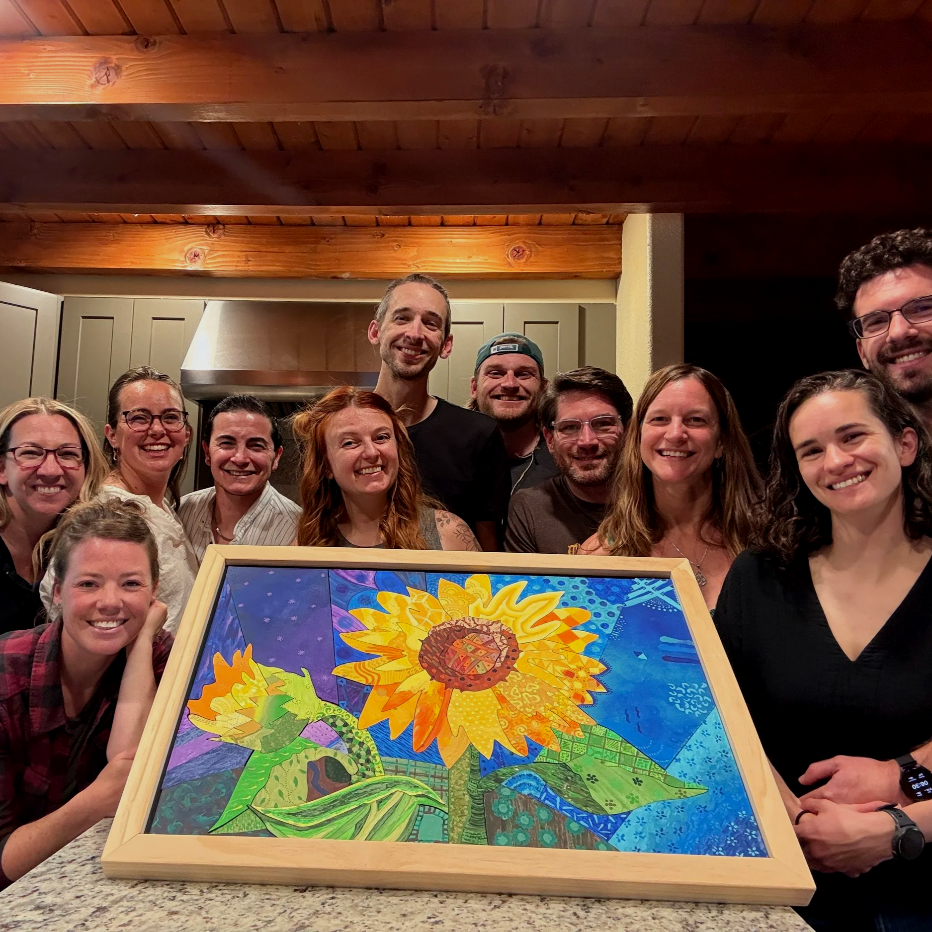 A group of friends smiling with the collaborative art they created