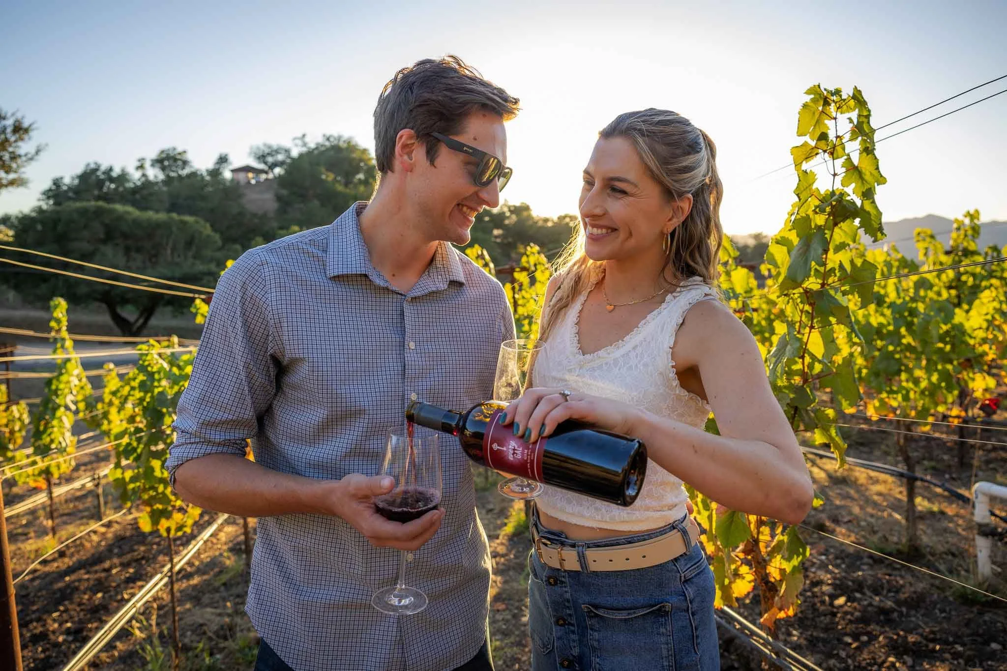 Julia Ilsley and her husband pour wine in the vineyard