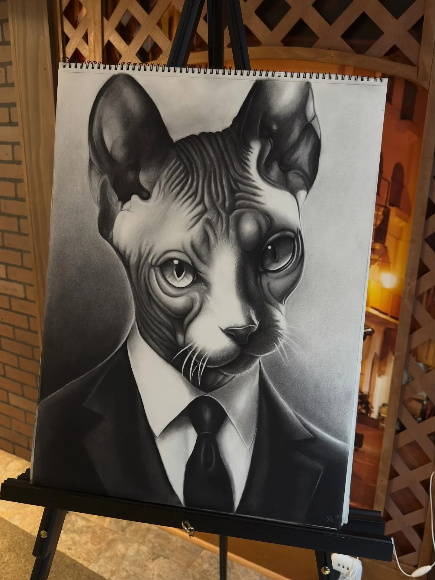 Some pieces hang on a wall.
Others observe the room.

This one is always watching.

Charcoal piece by me. What do we name him?