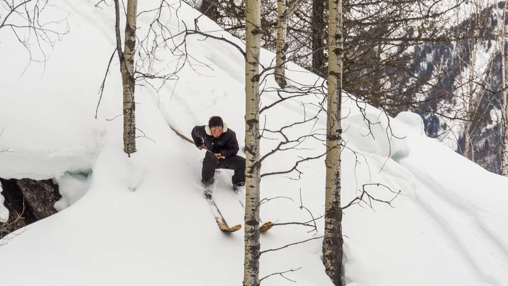 A local from the Altai Mountains demonstrates the use of a single pole while downhill skiing.
