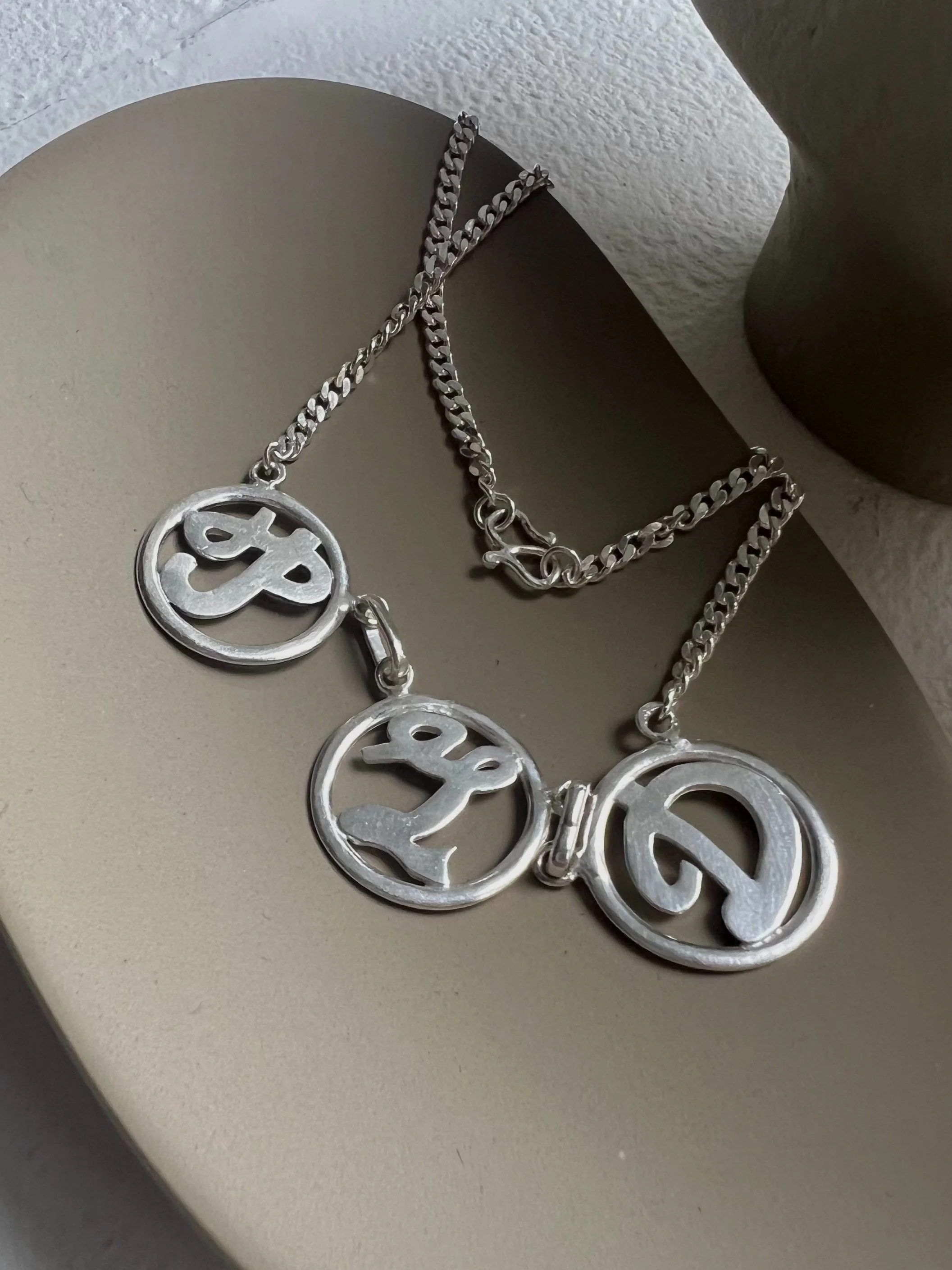  Family necklace with our initials designed by mom. Made in Pure Silver 