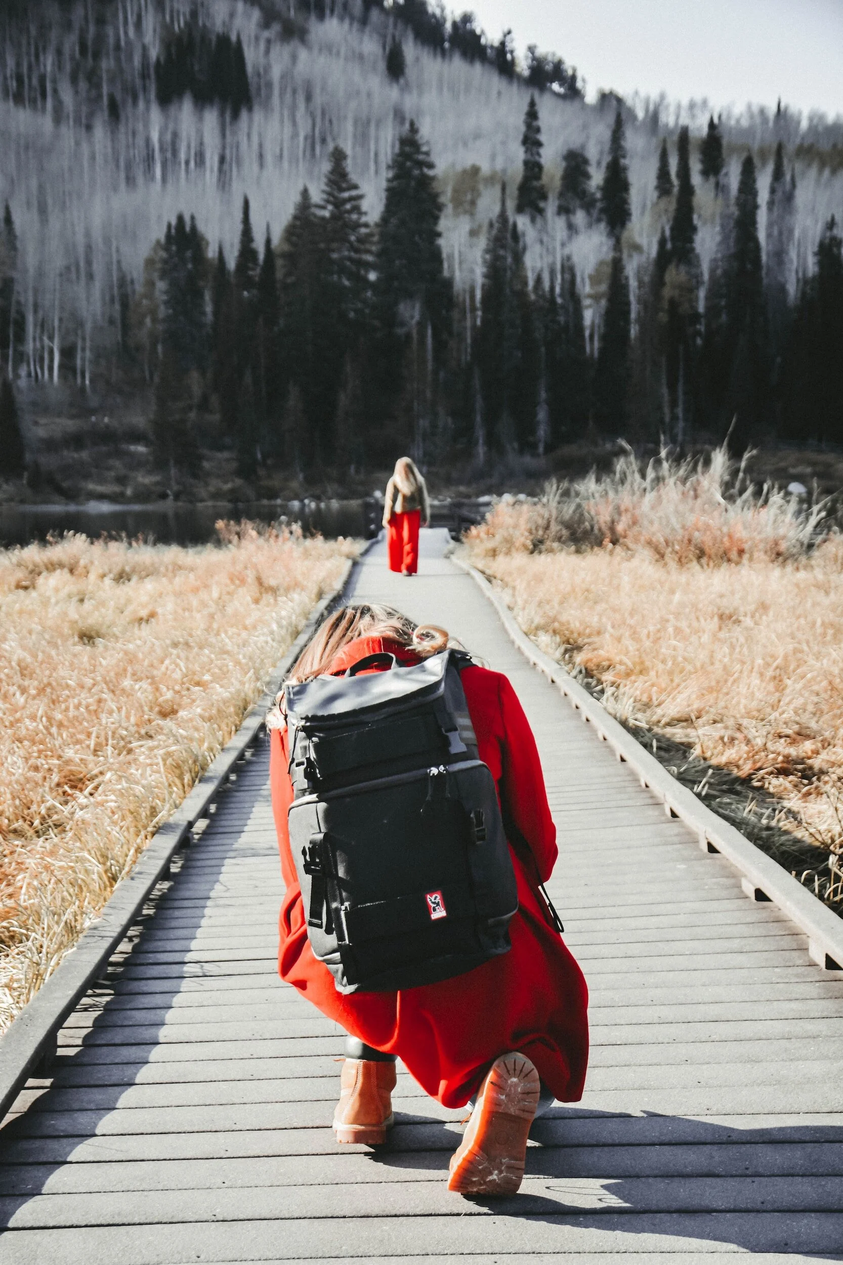 Photographer taking picture of woman in nature