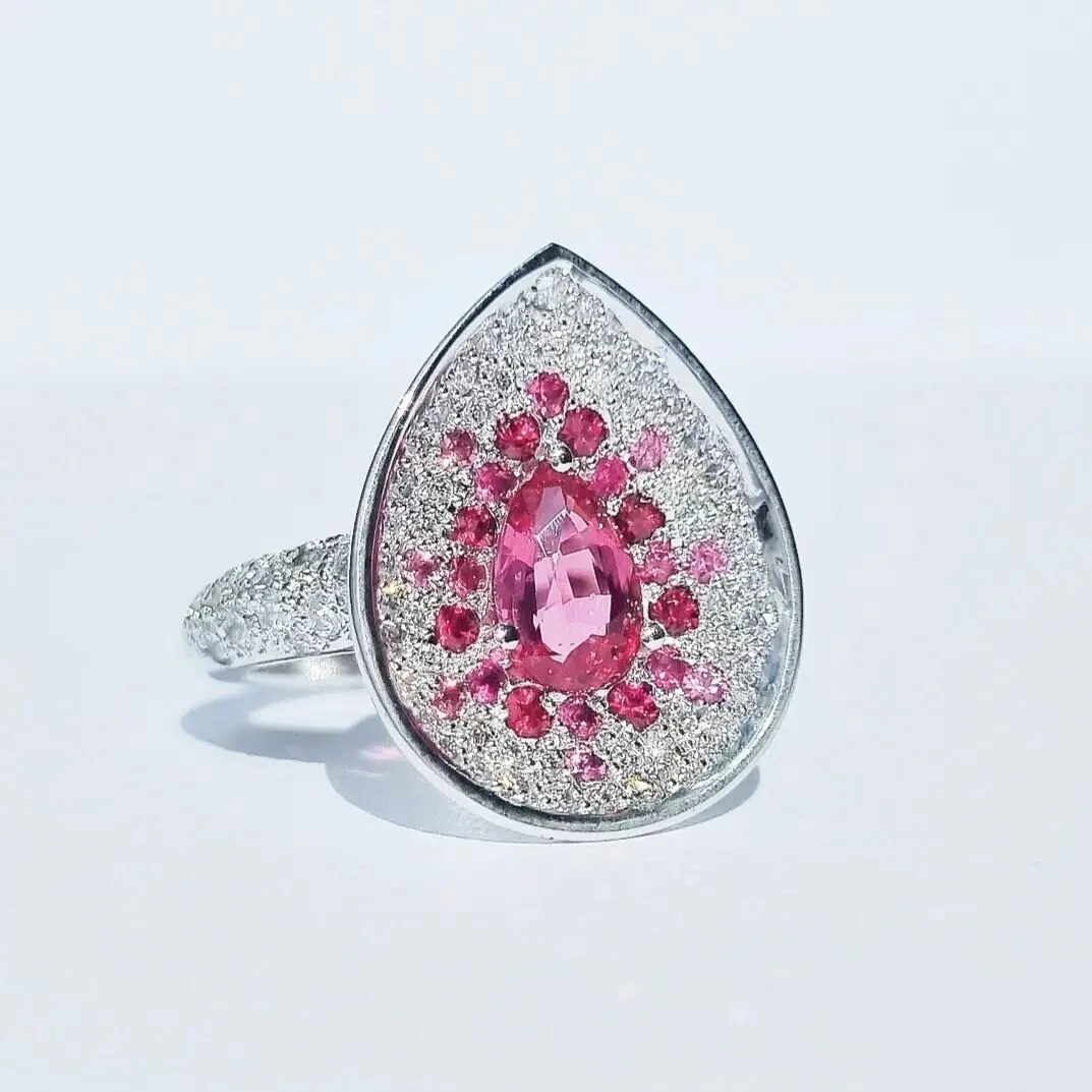 AVAILABLE! Dm for details. Something a little different I really wanted to showcase this beautiful 1ct blood red spinel in a unique way. The round spinels surrounding it go from matching to gradually getting lighter as it fades into diamonds. Set in 