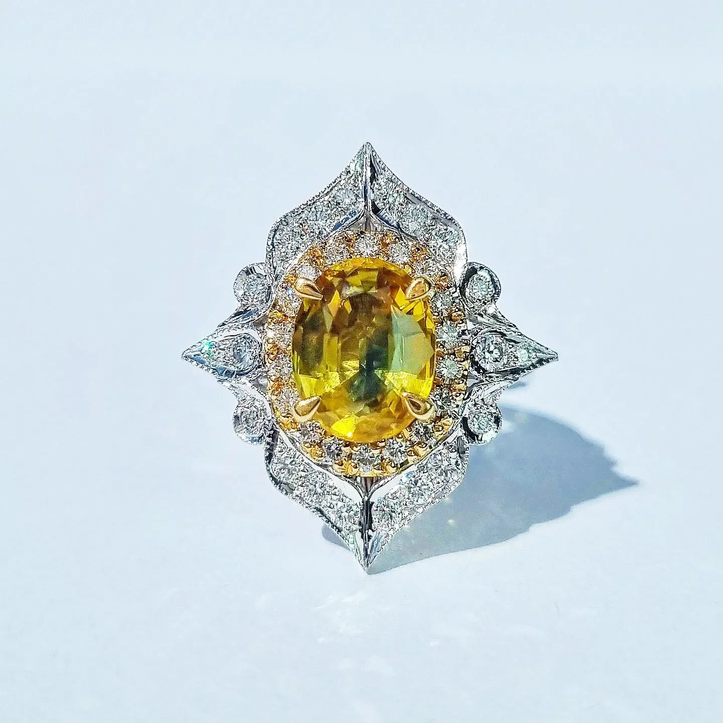 Got a nice photo of the ornate 'parti' sapphire ring from our personal collection this morning. Parti sapphires are such fun no two are the same this one is a 3ct beautiful golden yellow colour with a green wave through the centre. Surrounding it a d