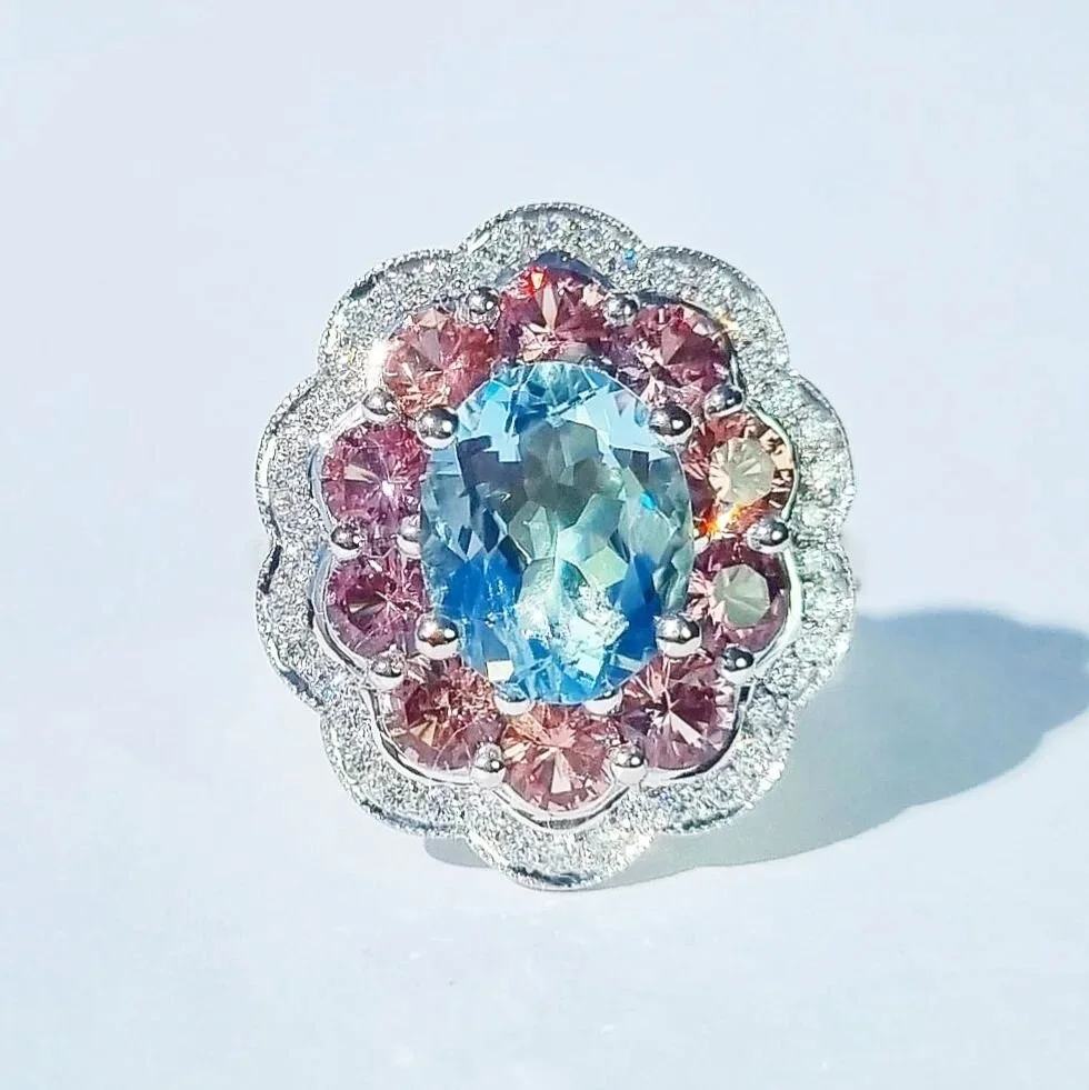 Another all time favourite! I swear I say that about every piece but I love them all. This bold daisy showcases a rich 3ct aquamarine surrounded by mushroom pink Malayan garnets, all tucked in tightly to create a bouquet of colour. Framed with diamon