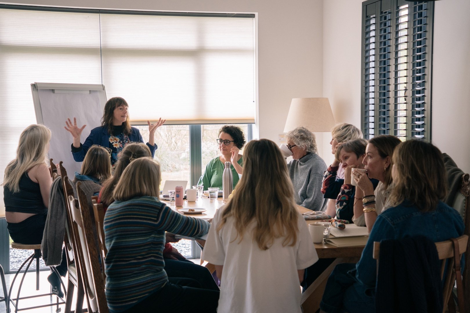 Foggy morning view of Lewes Castle in Sussex, with rooftops and chimneys in the foreground and rolling hills in the background.