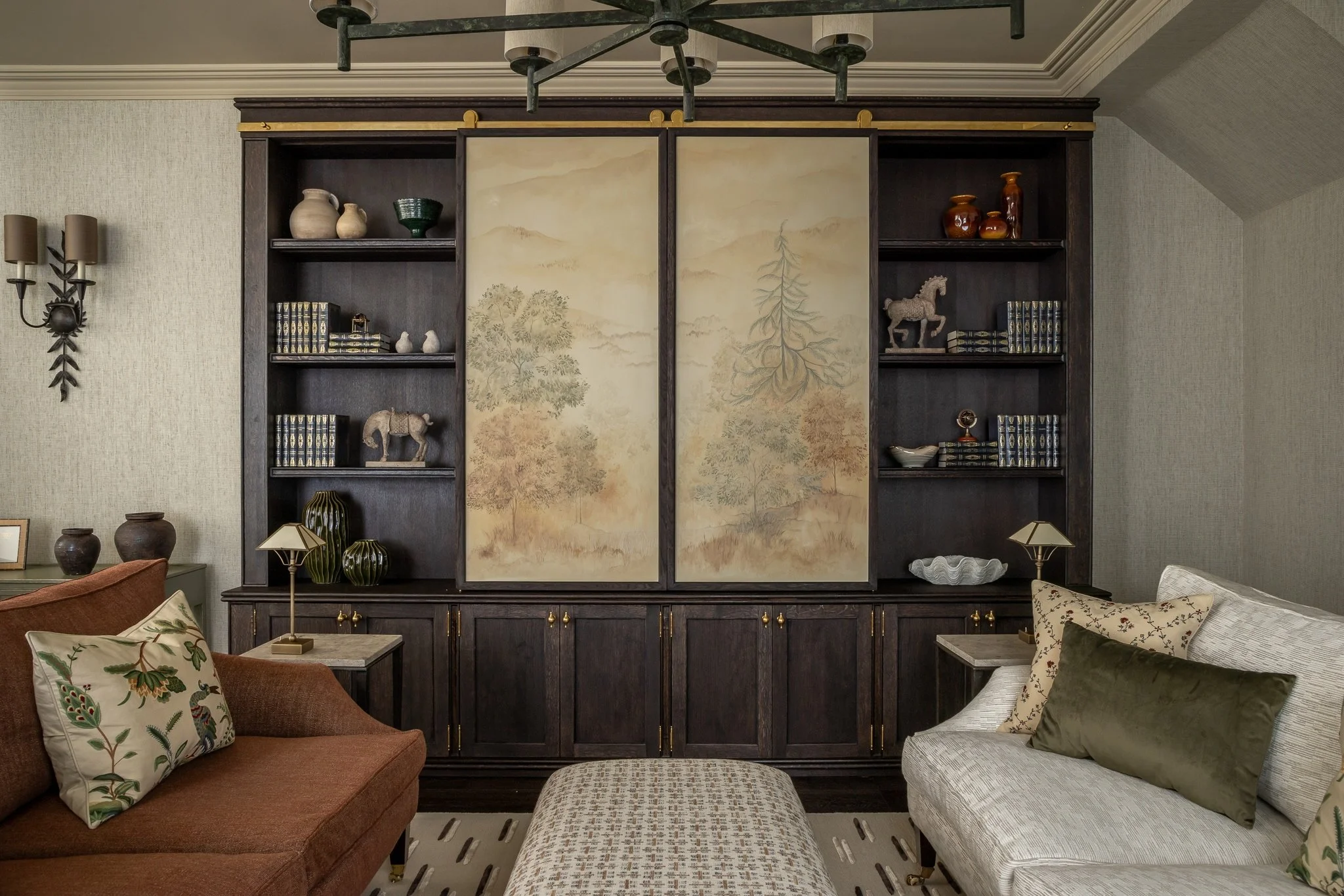 Luxury living room design in London featuring bespoke dark wood cabinetry, a hand-painted folding screen, and elegant traditional furniture curated by Joel Azevedo.