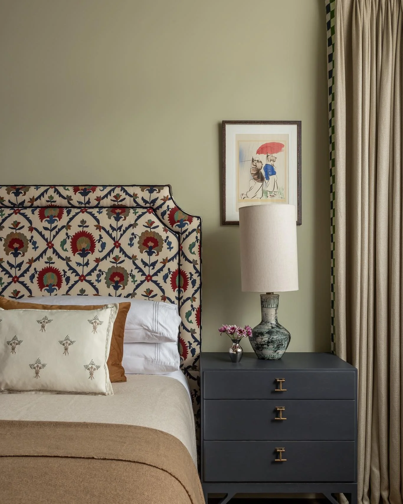 The upholstered headboard is the hero of this bedroom &mdash; adding a soft, inviting layer that makes you want to lie in bed and enjoy the space.

We chose a Suzani-inspired fabric for its traditional pattern, texture and warmth, creating a gentle c