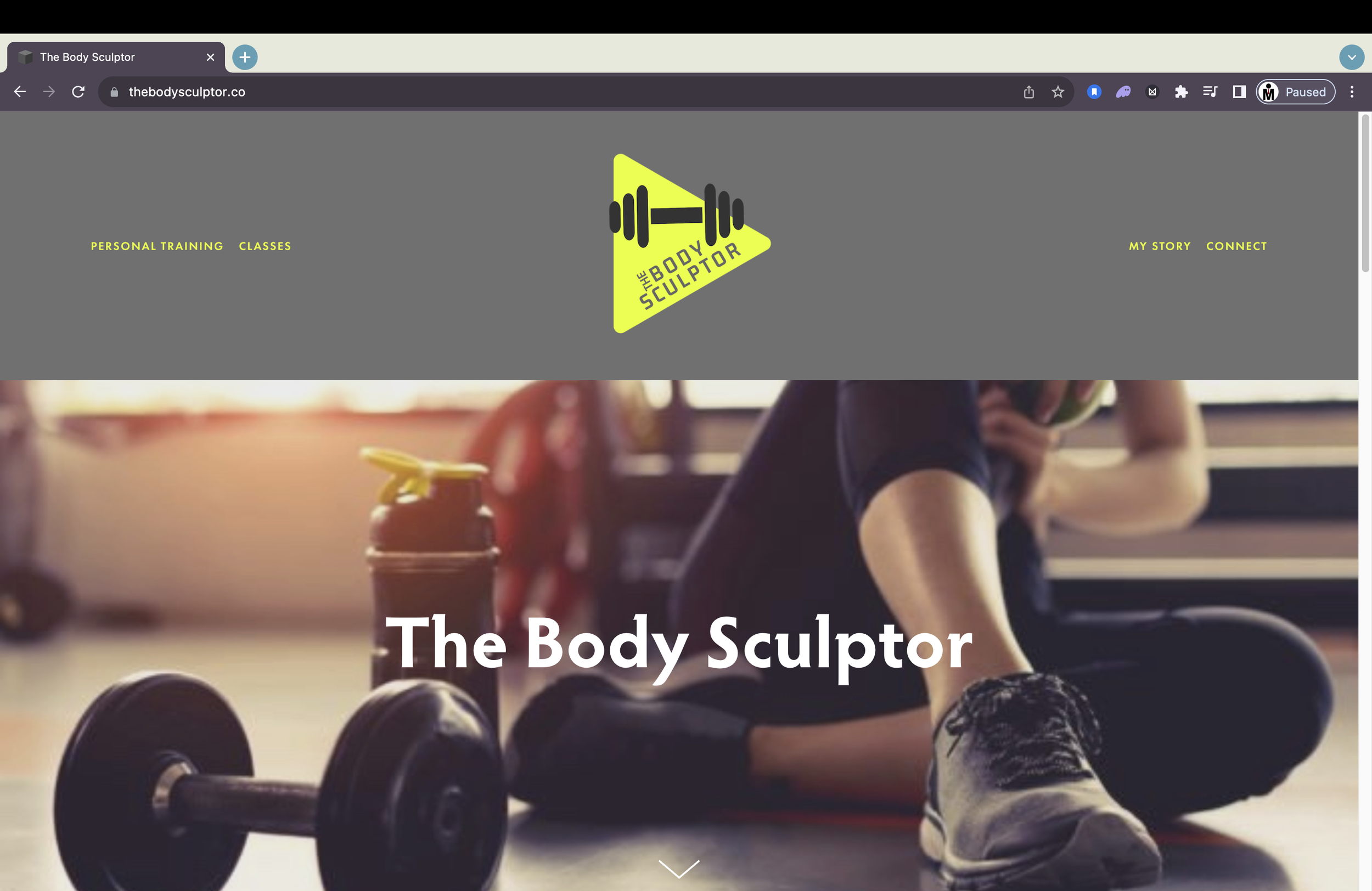 A website homepage for The Body Sculptor, with a logo featuring a barbell inside a yellow triangle. The background shows a person sitting on the gym floor with a water bottle, a dumbbell, and blurred gym equipment, emphasizing fitness and personal training.