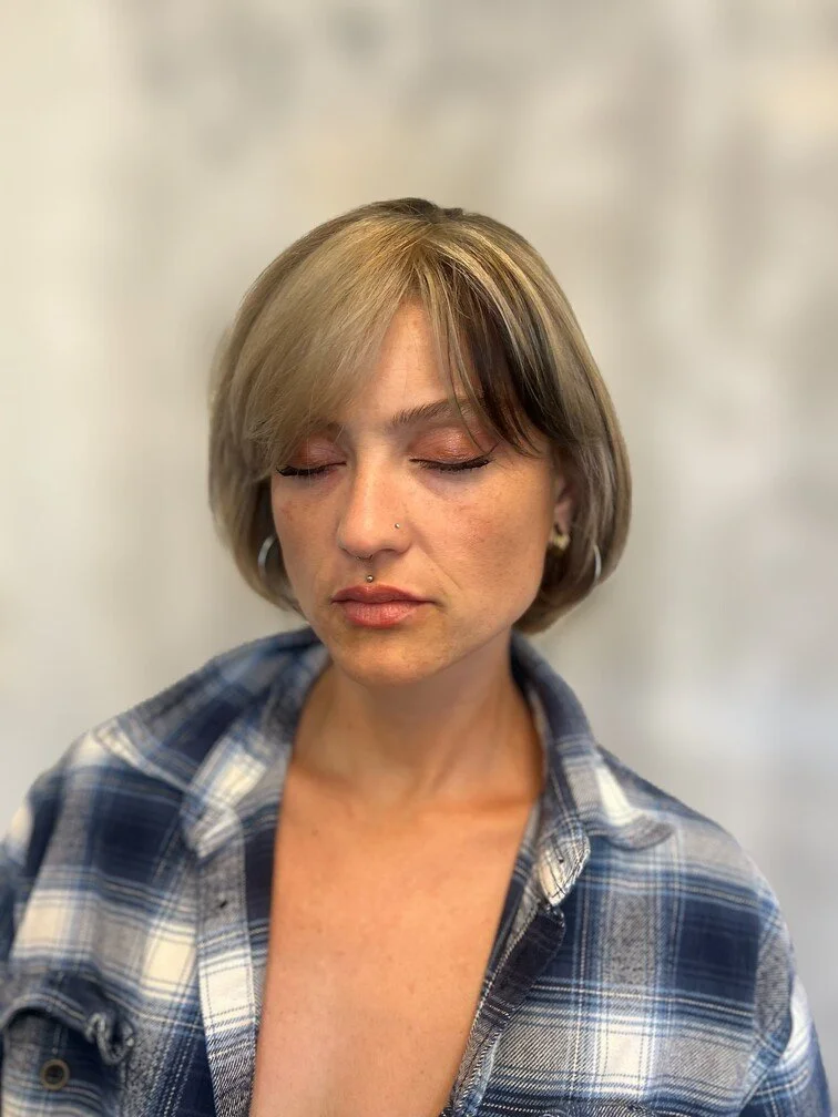 woman with eyes closed shows blonde and brown bob