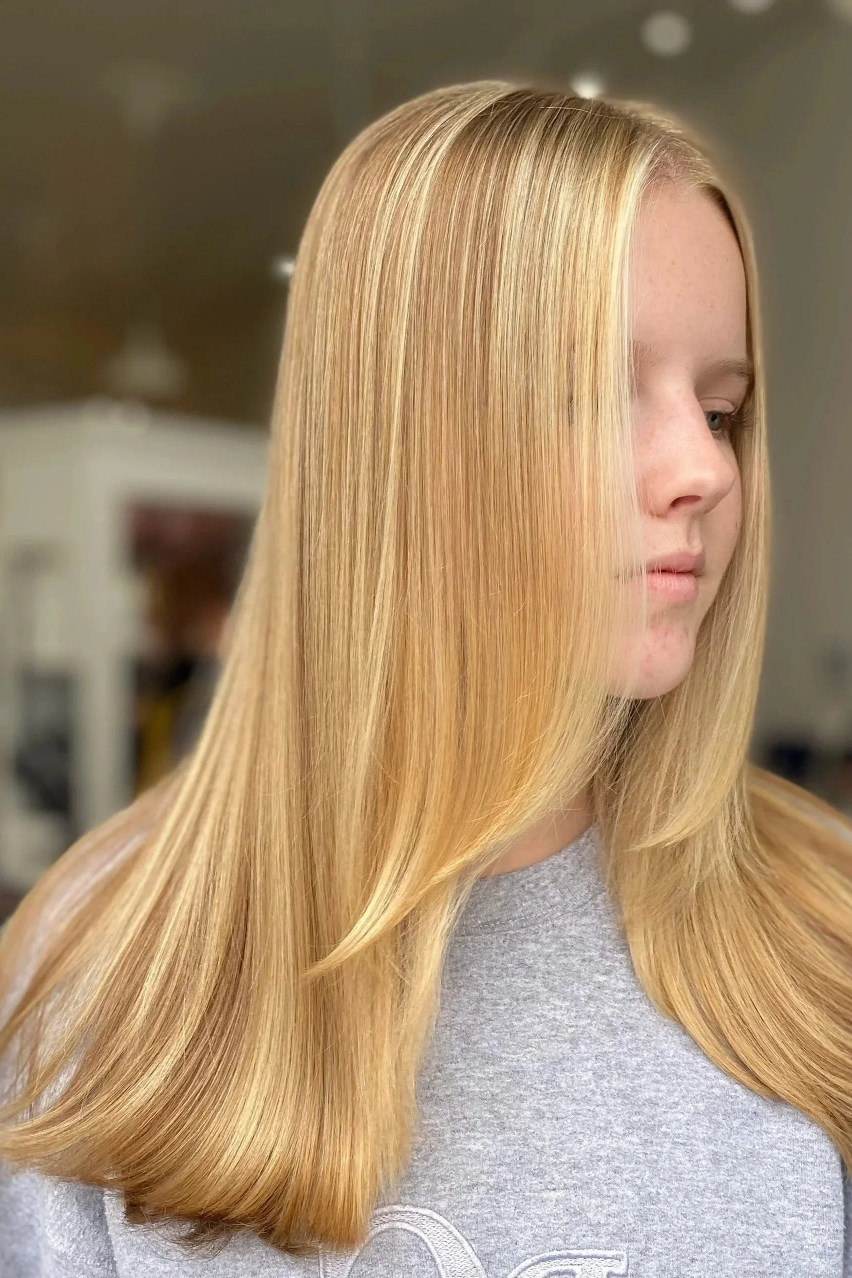 front face side view of strawberry blonde highlighted hair of girl