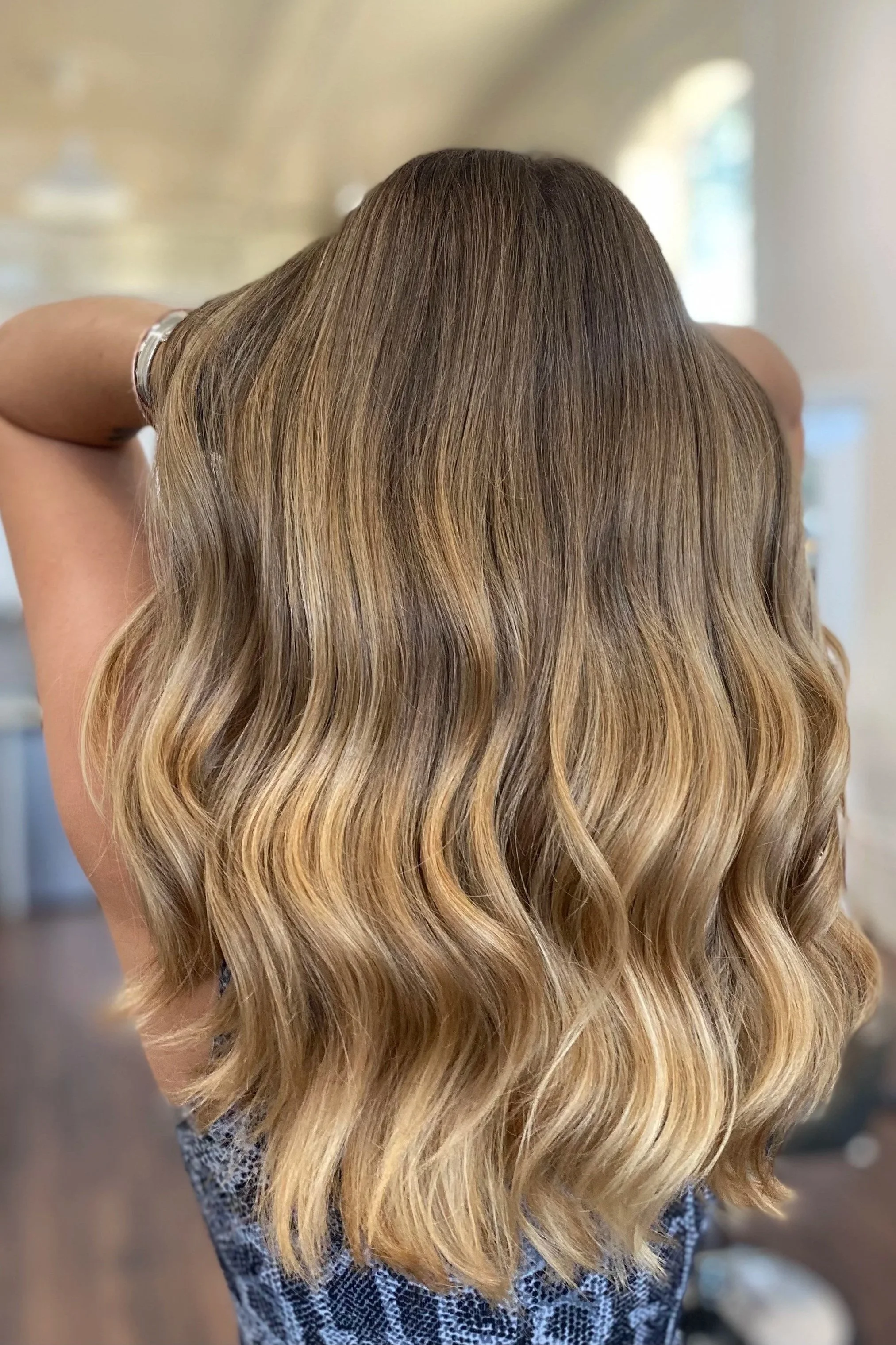 back of the head of long haired brown highlighted hair