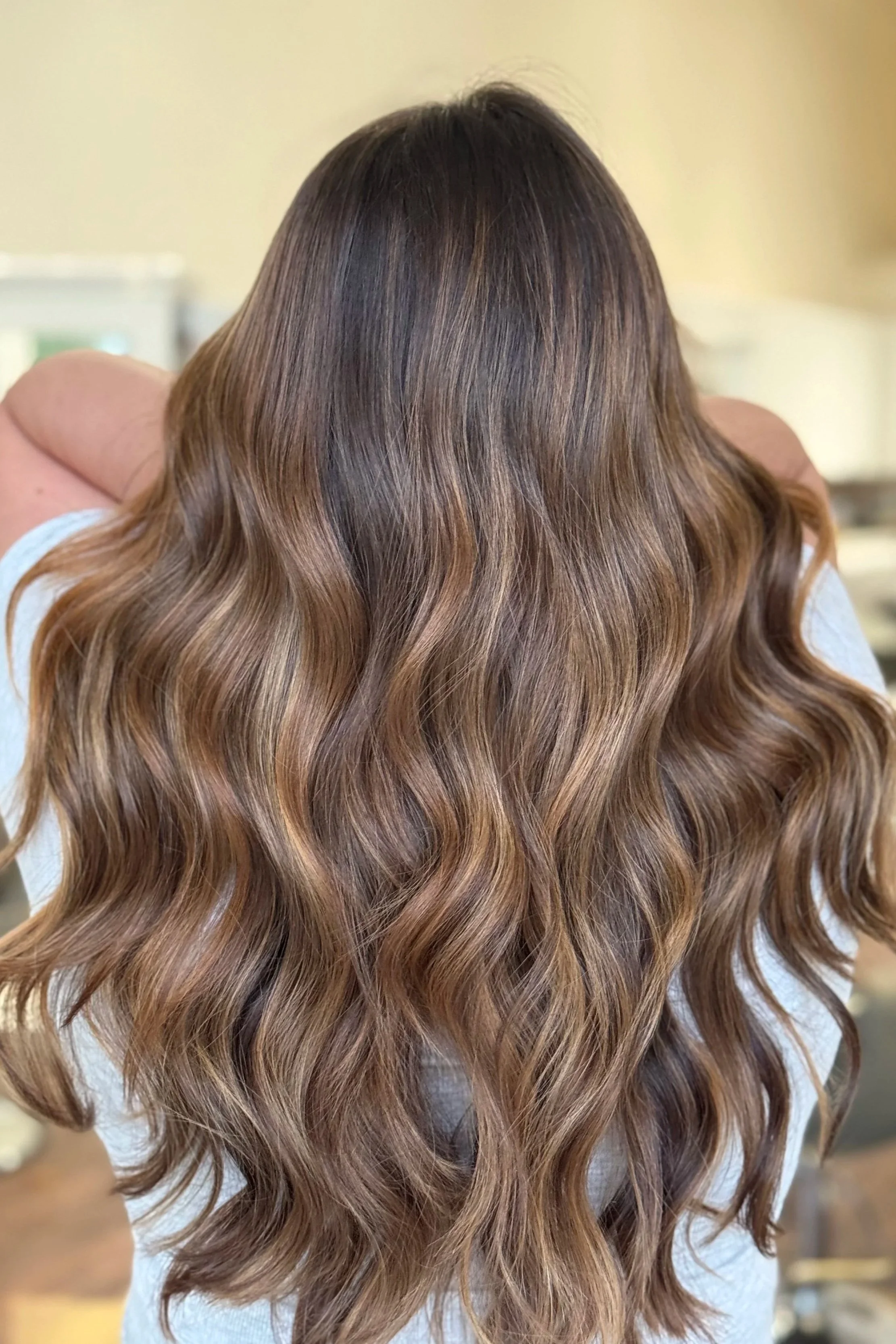 back of the head of long haired brunette girl