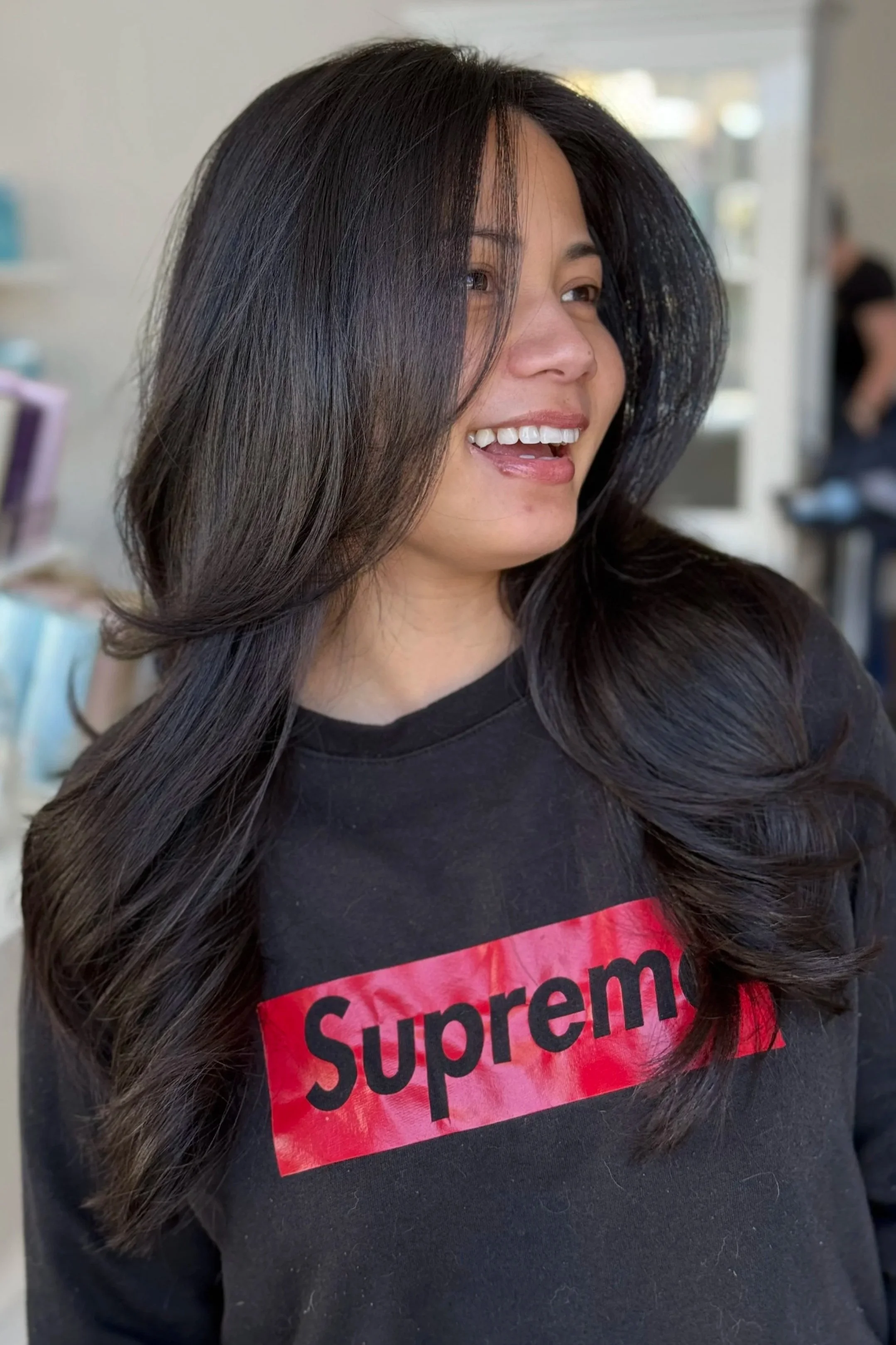 smiling face with layered dark brown haired girl
