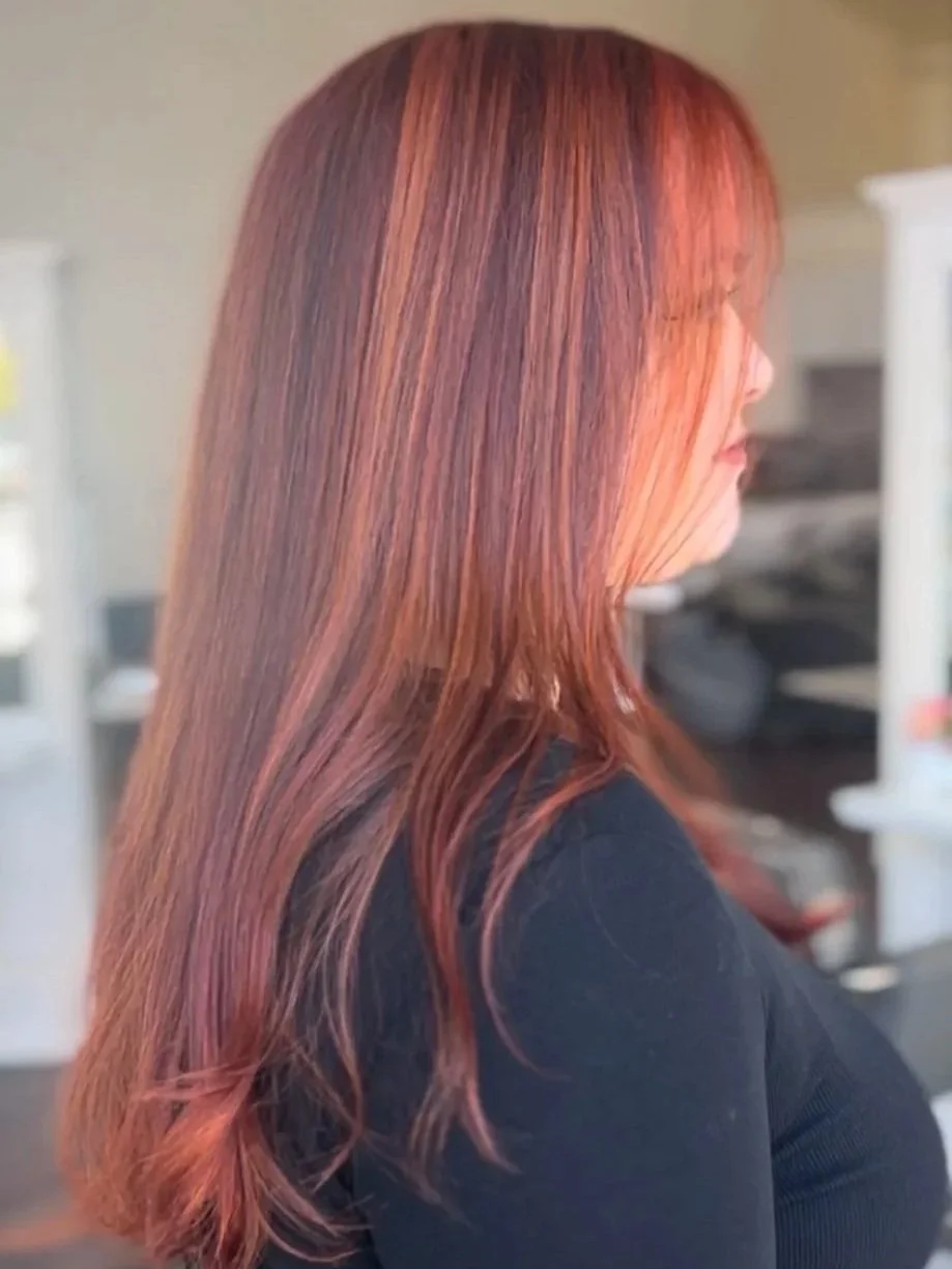 side profile of woman with red highlighted hair