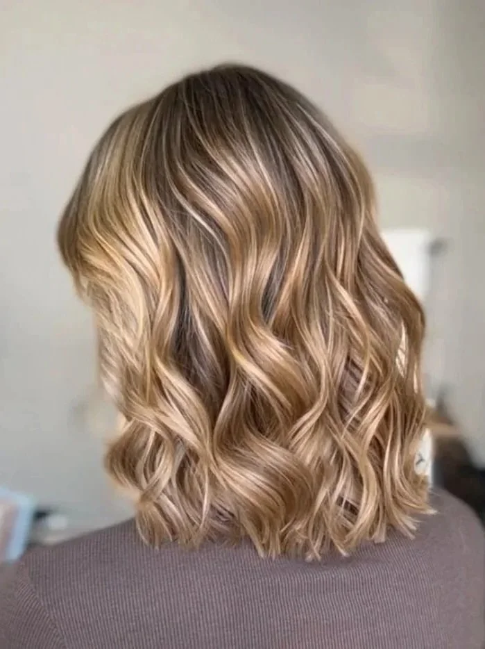 back profile of woman with short, blonde highlighted hair