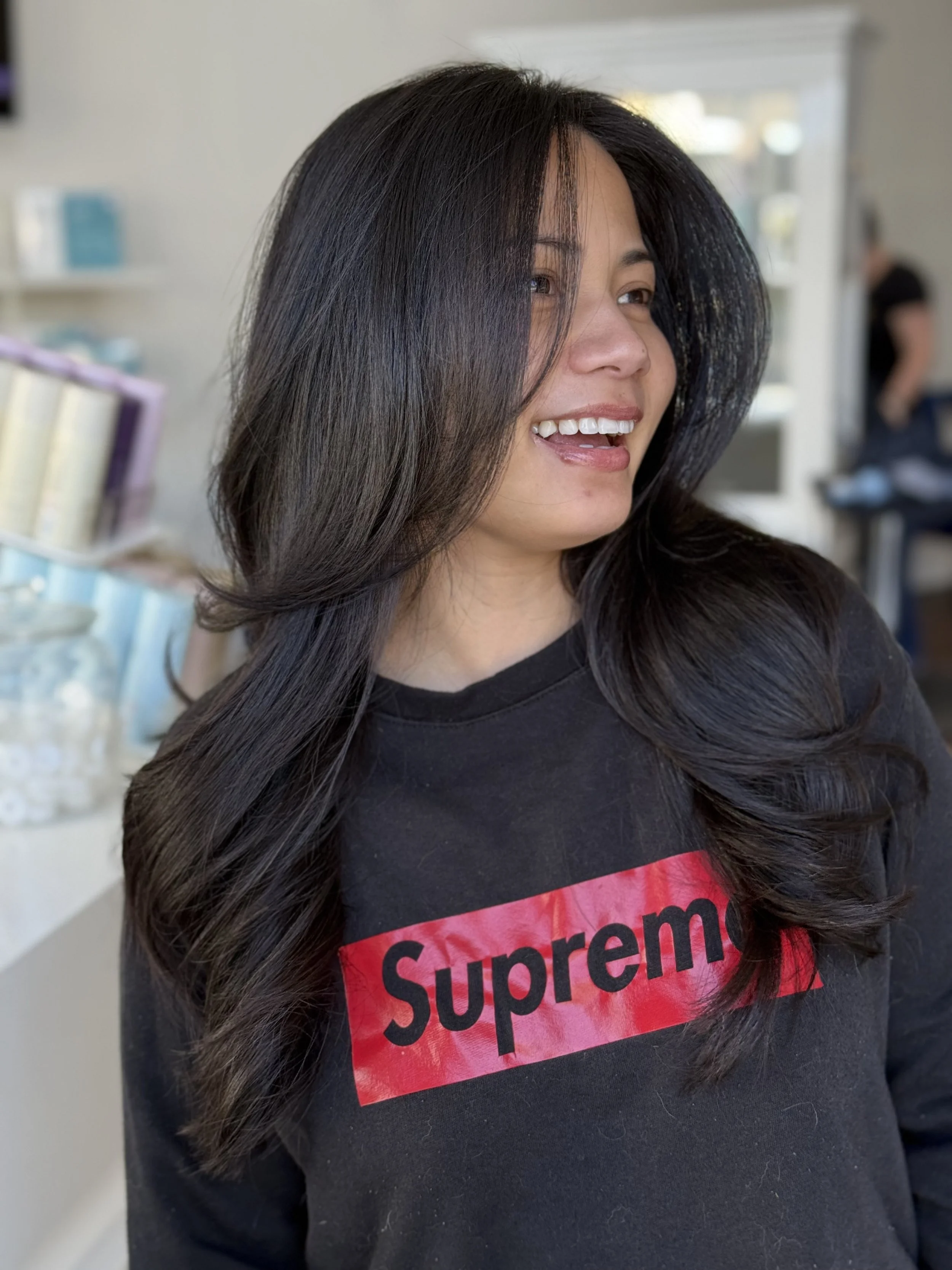 smiling face with layered dark brown haired girl