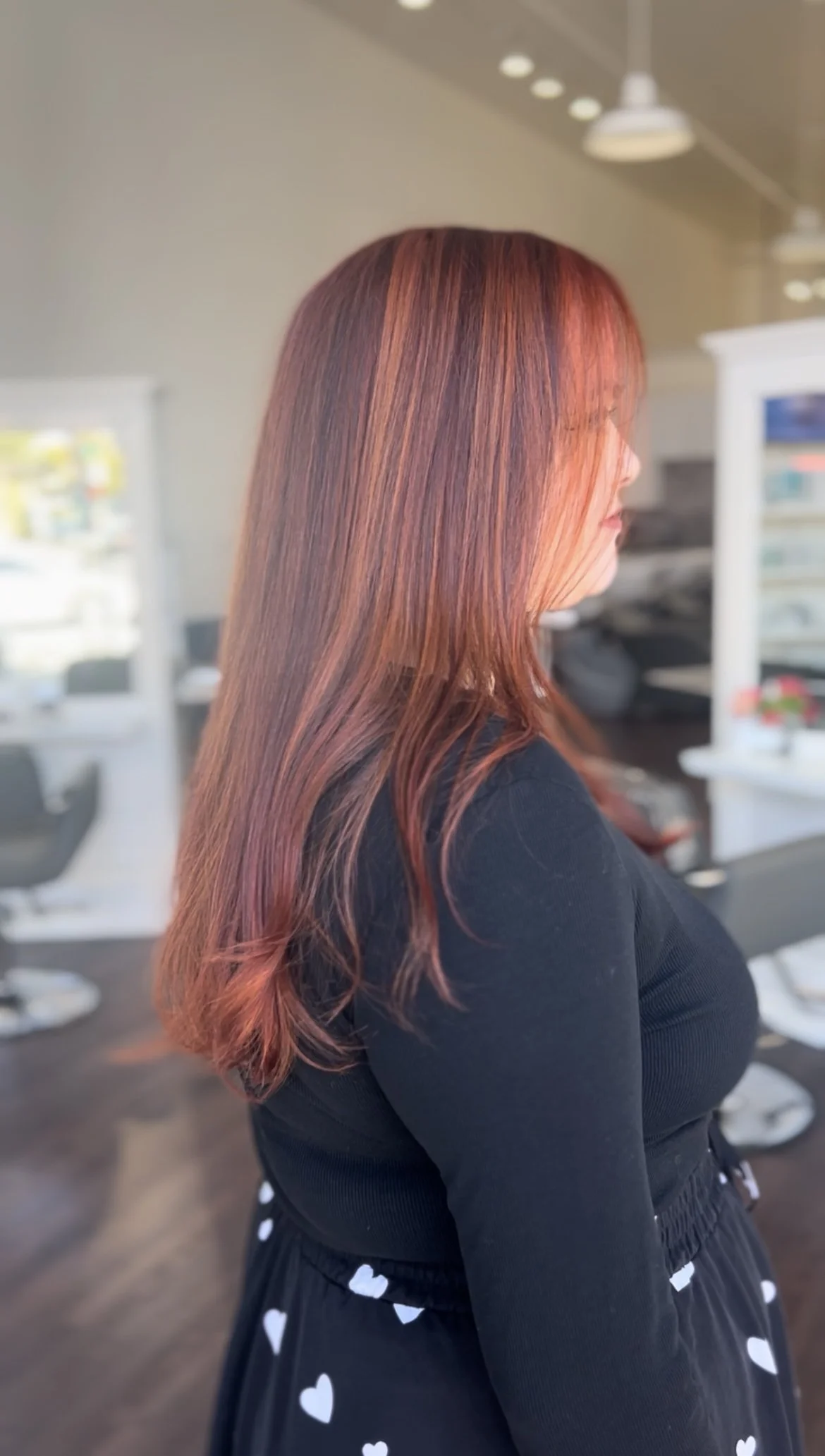 side profile of woman with red highlighted hair