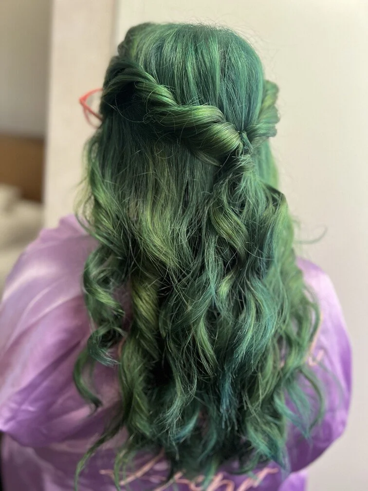 woman with green loong curly hair