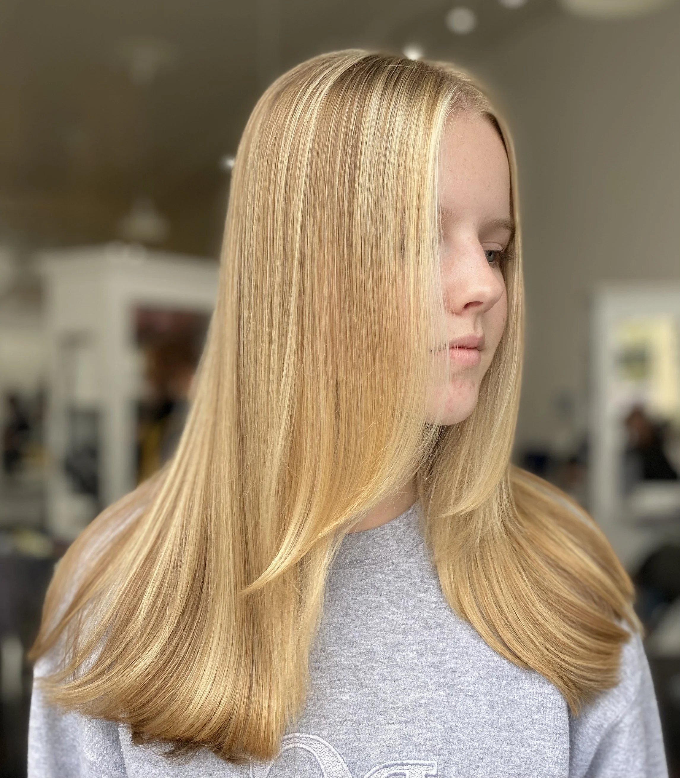 front face side view of strawberry blonde highlighted hair of girl