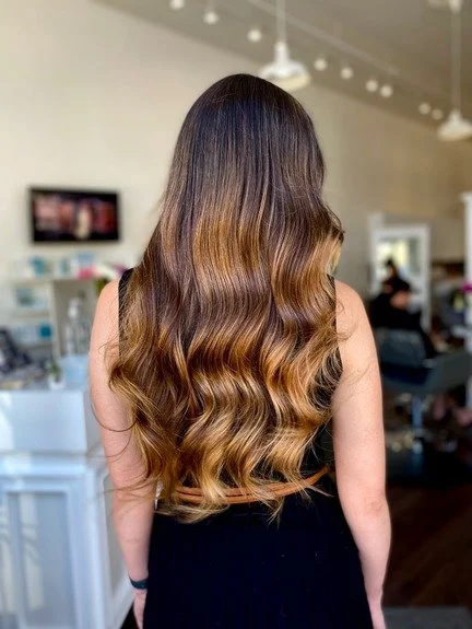 finished work of long caramel brown balayage dark hair with waves