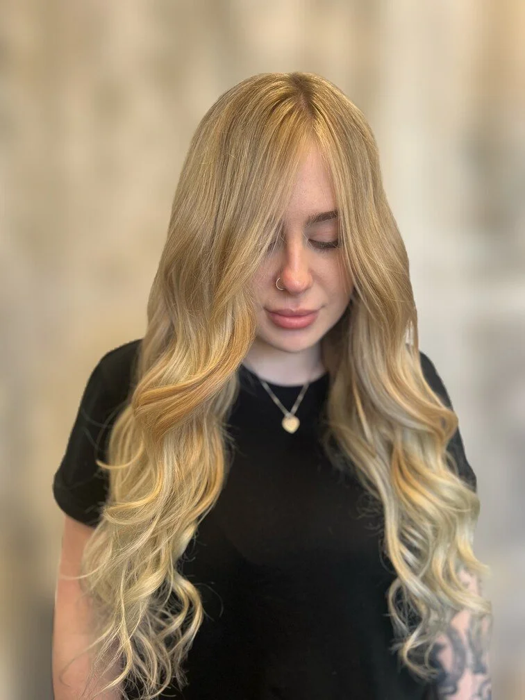 woman with loong blonde curly hair