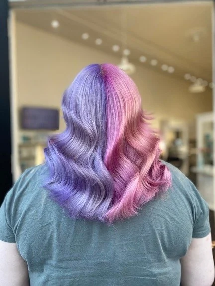 portfolio woman has pastel pink and purple hair, shoulder length, with waves