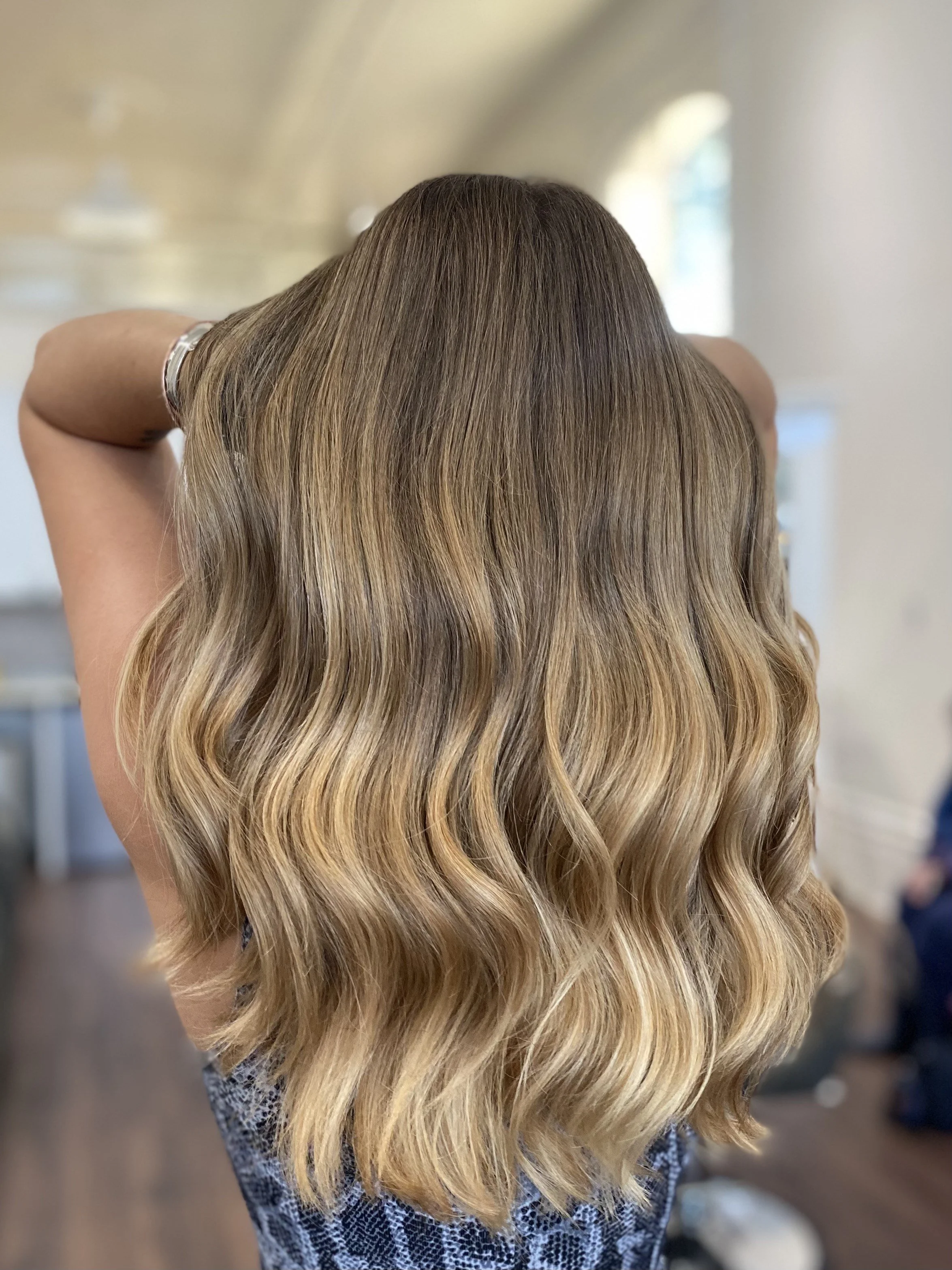 back of the head of long haired brown highlighted hair