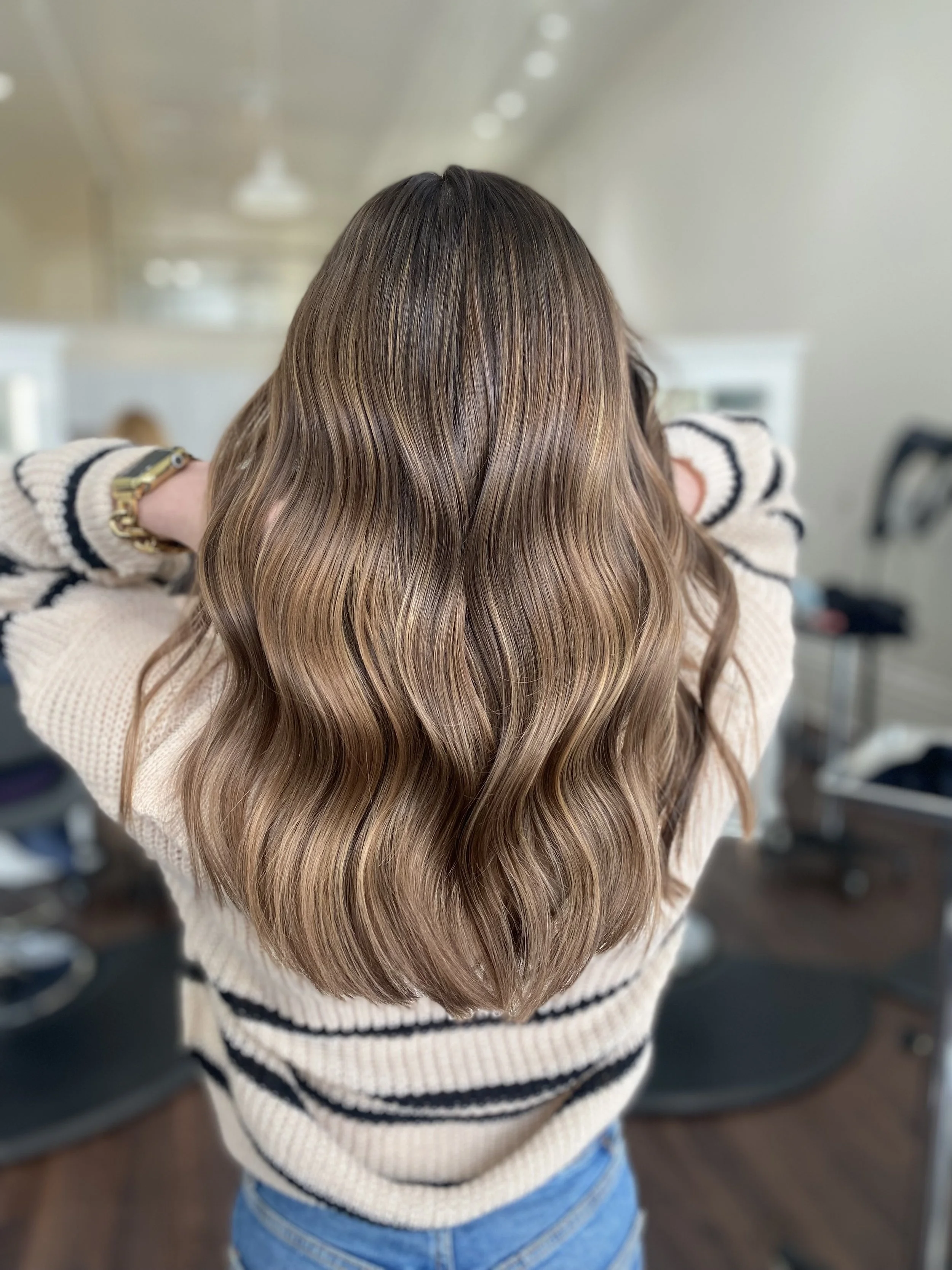 back of head of brown shiny haired girl