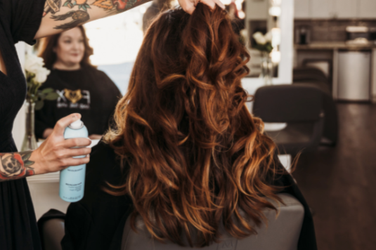 back of woman's red curly hair