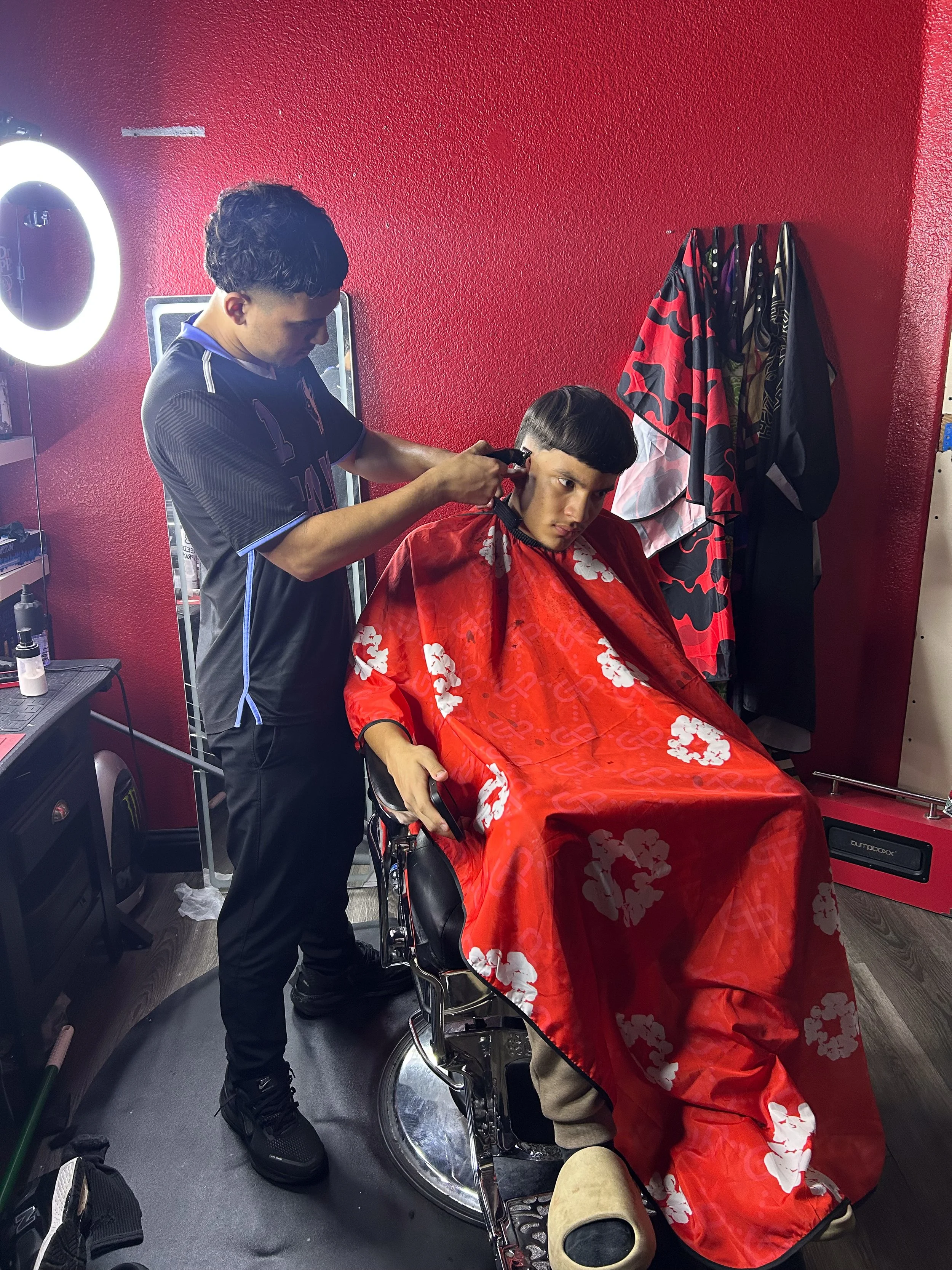  Jose Rios standing cutting Leo Rivas in his house. This picture was Taken at Jose Rios house in Manteca California on Feb. 4, 2026. (Raul Figueroa/The Tower)&nbsp; 