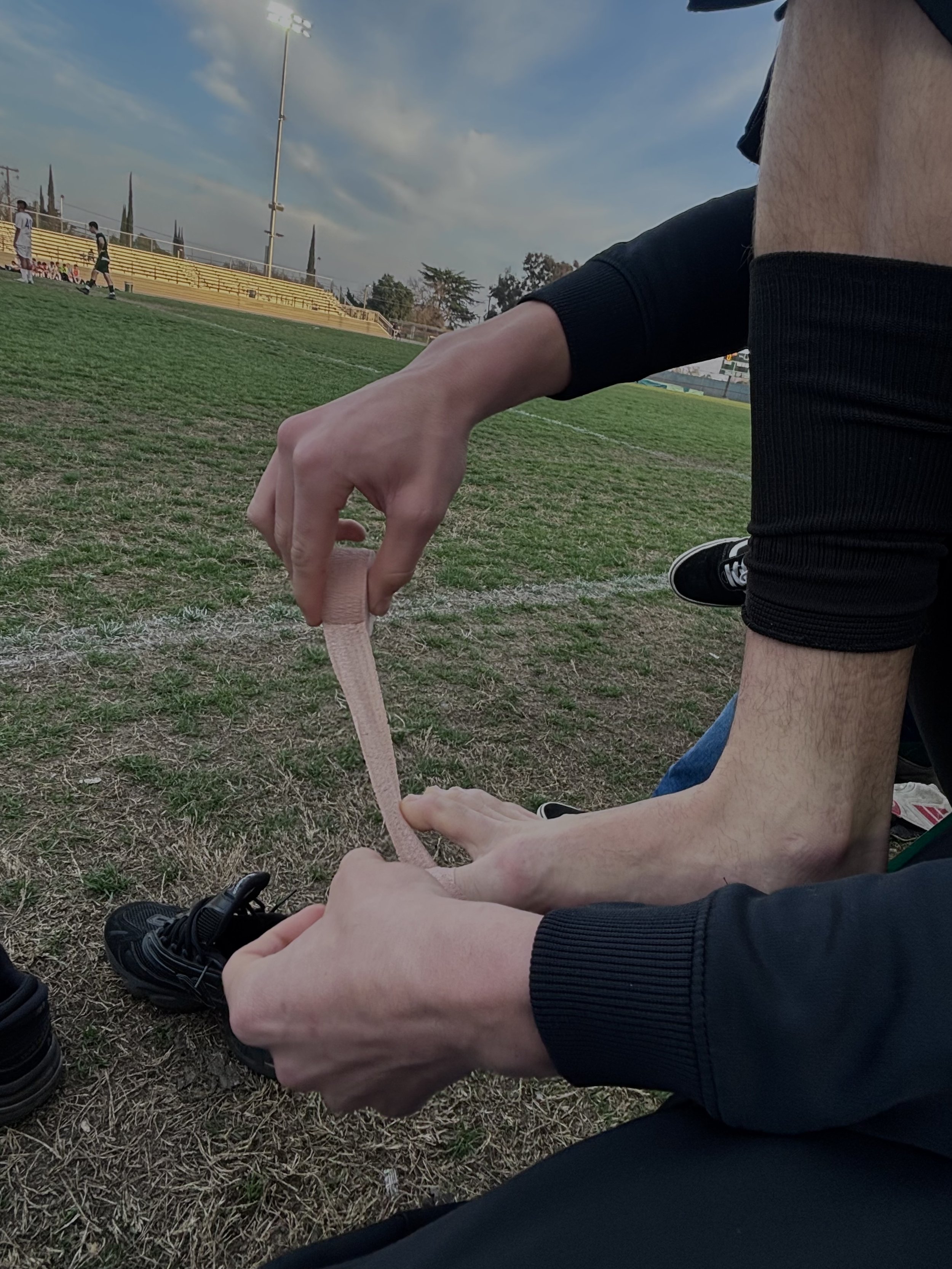  Mateo Esparza doing his game ready routine, taping his toes and making sure everything is as secured as possible in order to get the best results against mountain house for senior night, February 5, 2026. (Christian Ambriz/The Tower) 
